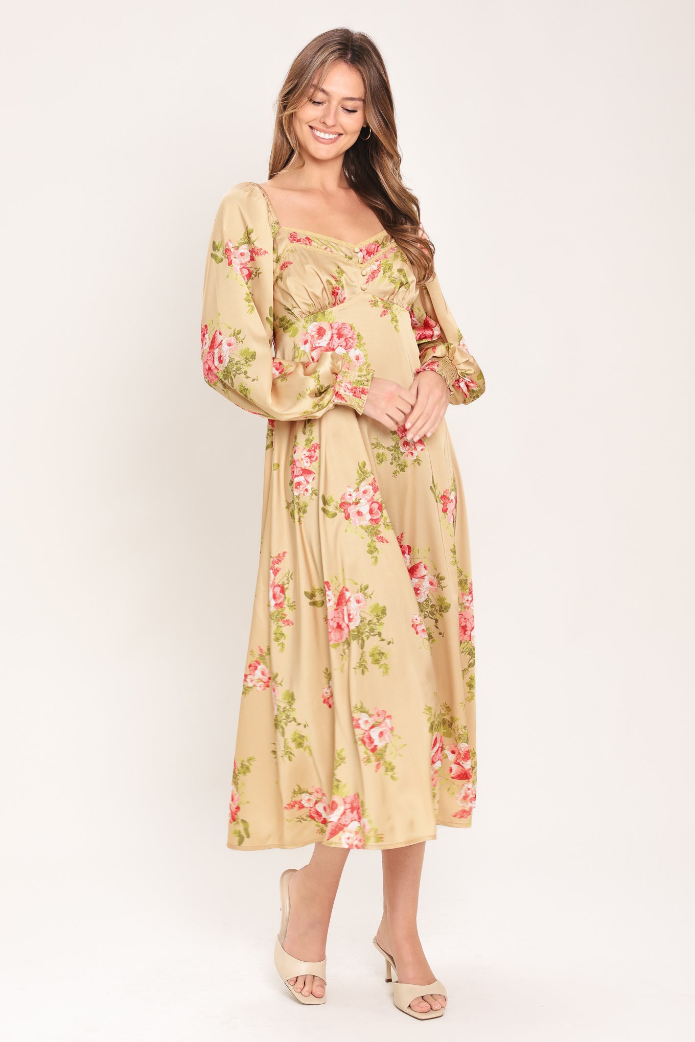 Woman wearing a long sleeve with smocked cuff champagne midi dress with floral print featuring sweetheart neckline, empire waistline, circle skirt and smocked back bodice | Flying Tomato