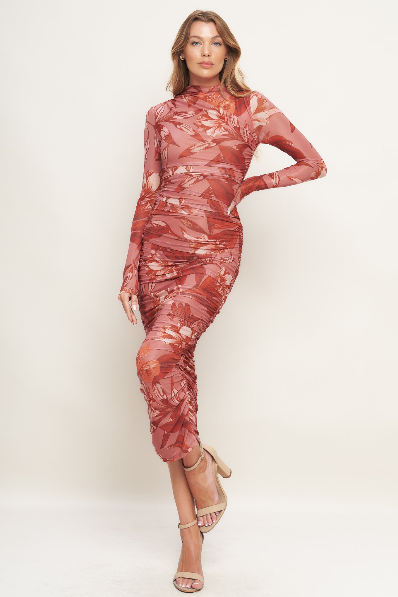 A printed power mesh midi dress featuring high neckline, long sleeve, side shirring and back zipper closure