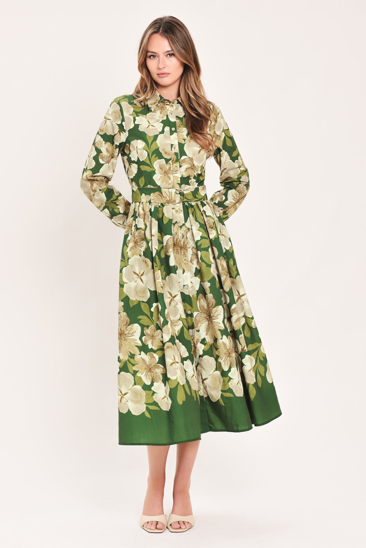 A woman wearing a long-sleeve midi dress with a green and cream floral print | Flying Tomato