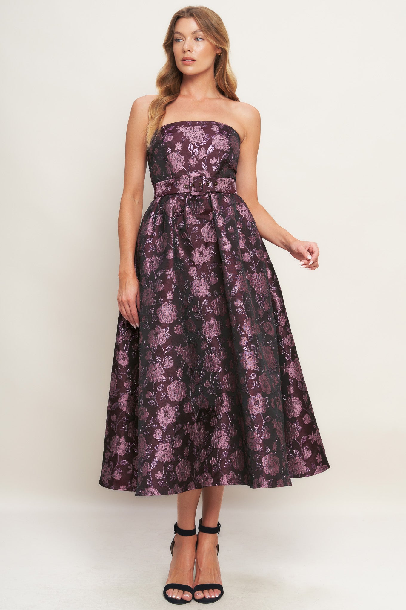 A jacquard woven midi dress featuring strapless neckline, self belt, full skirt and back zipper closure