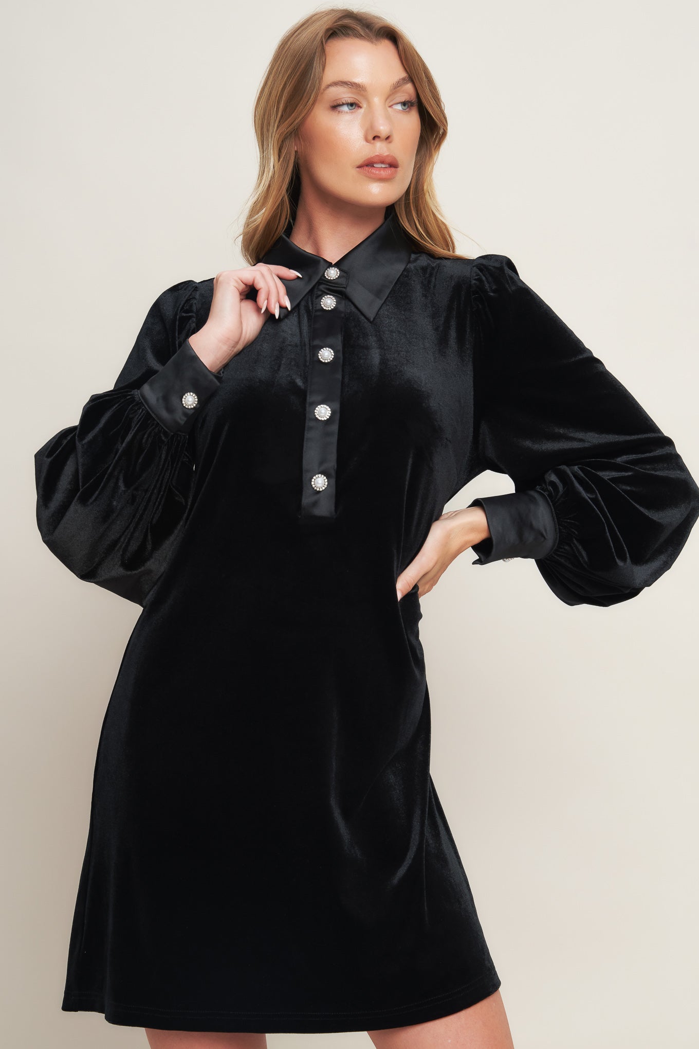 A solid velvet mini dress featuring contrasting collar and placet with jewel button and long sleeve with cuff
