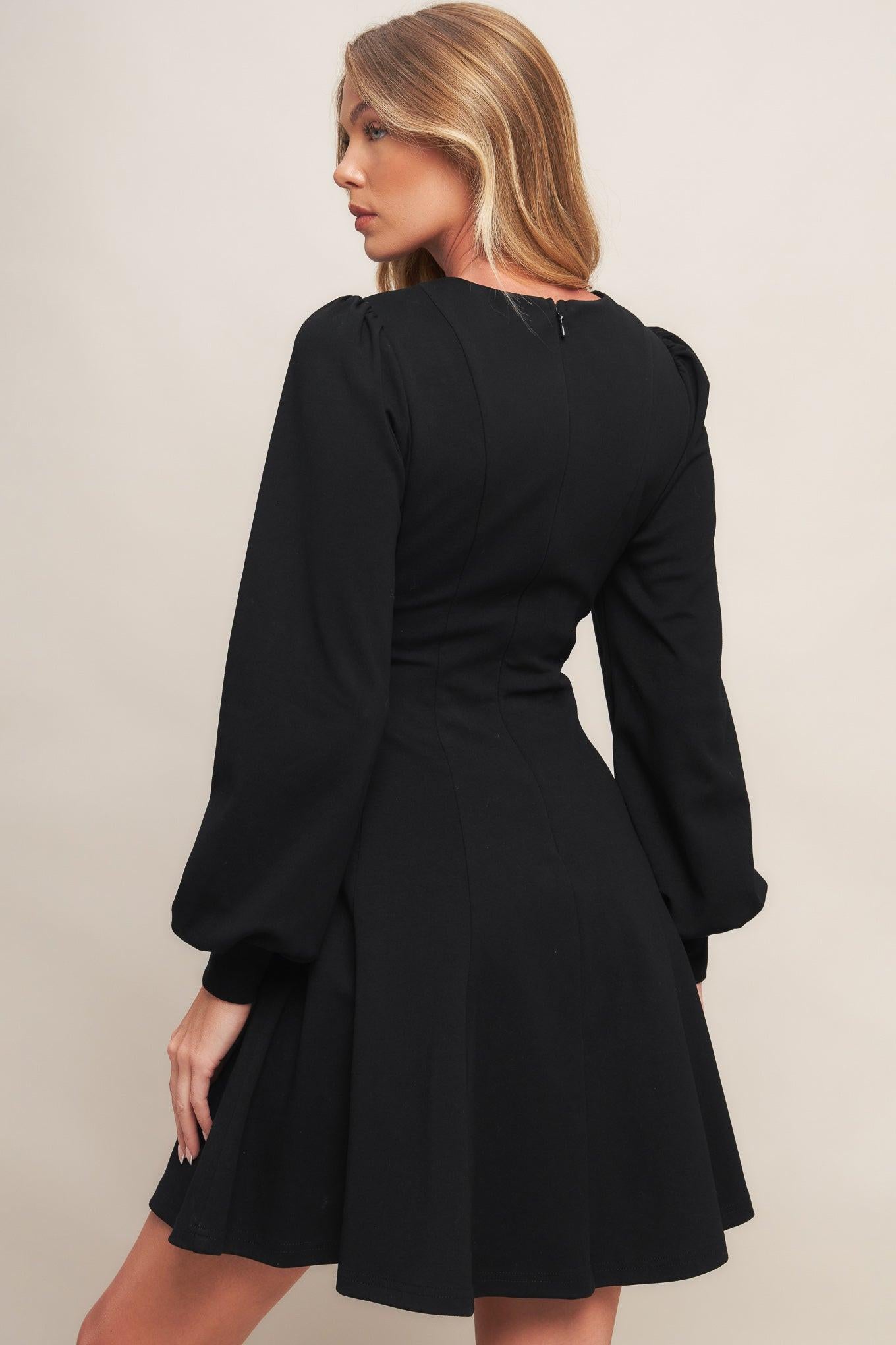 A solid heavy knit mini dress featuring round neckline, long sleeve with cuff, circle skirt and back zipper closure