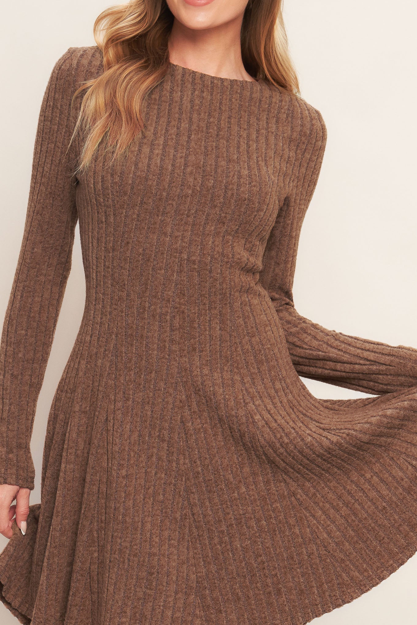 A brushed ribbed knit mini dress featuring round neckline, long sleeve, circle skirt and back zipper closure