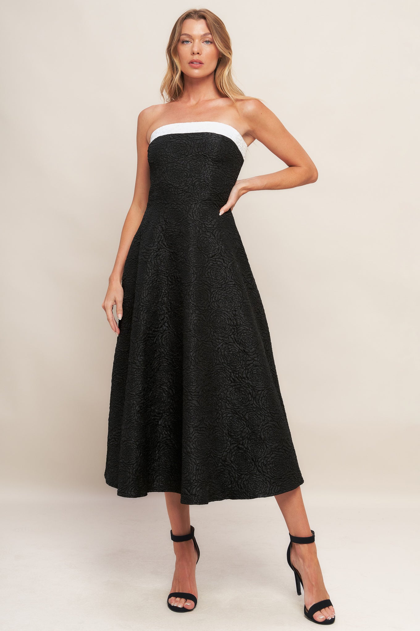 A textured woven midi dress featuring strapless neckline, circle skirt and back zipper closure