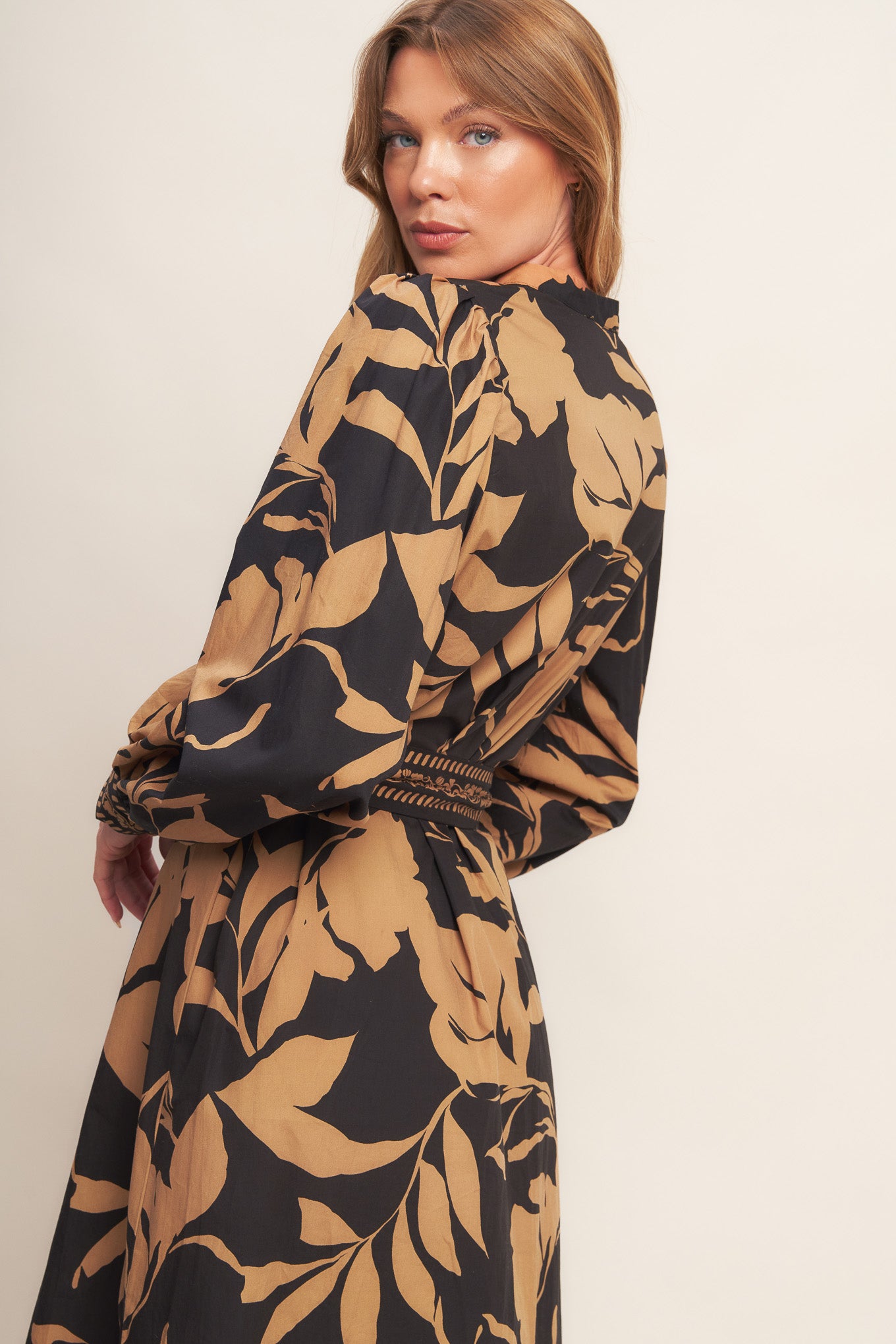 A printed woven midi dress featuring high neckline with V front, short puff sleeve and self sash tie