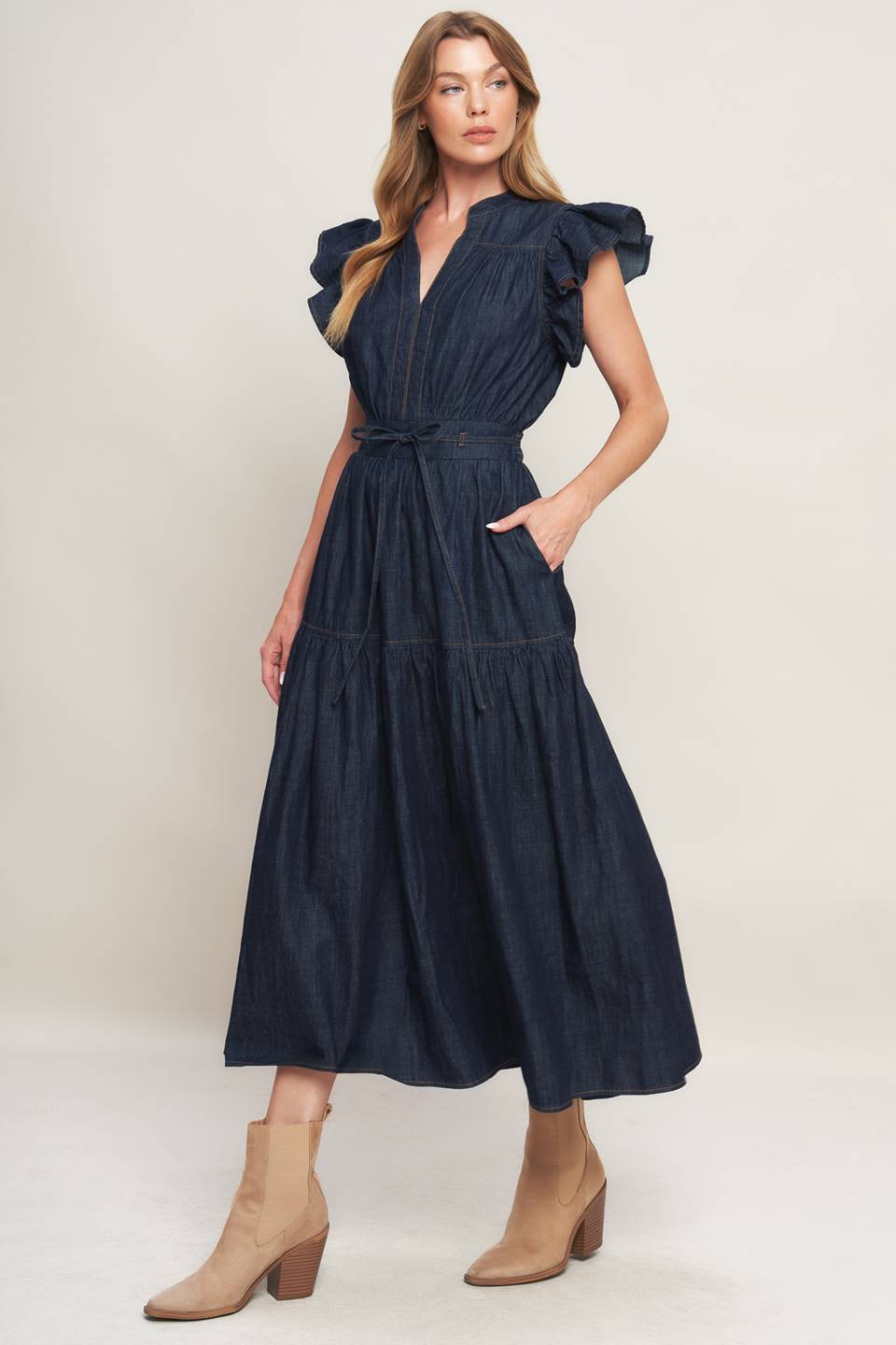A lightweight denim midi dress featuring V neckline, short ruffle sleeve, skinny self tie, tiered skirt and smocked back waistband