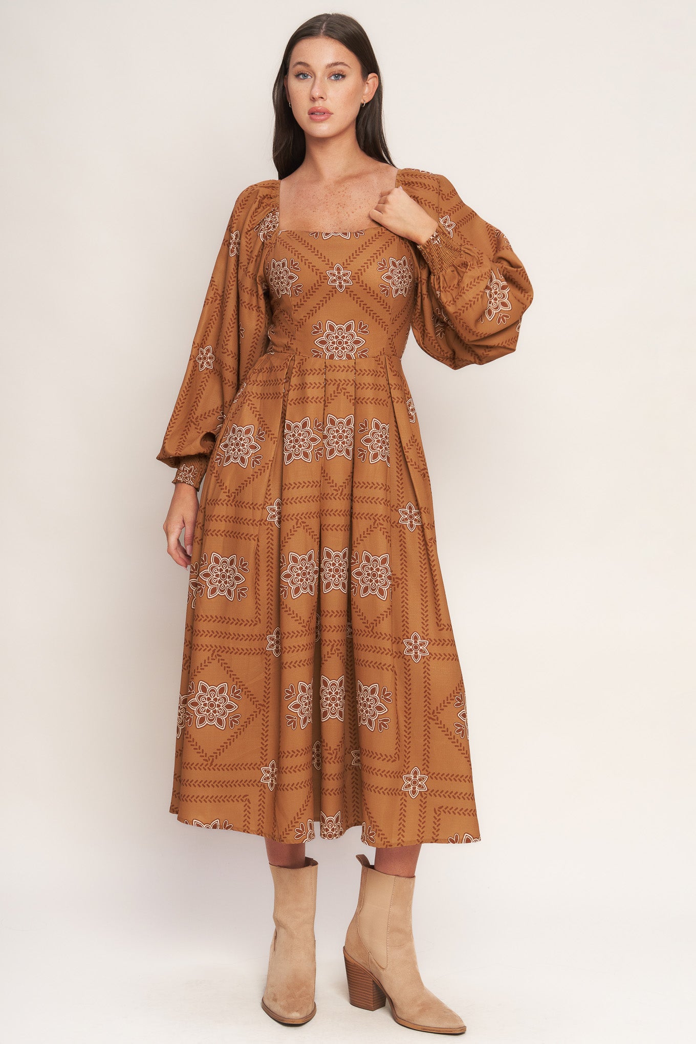 A printed woven midi dress featuring square neckline, long sleeve with smocked cuff, full skirt and smocked back bodice