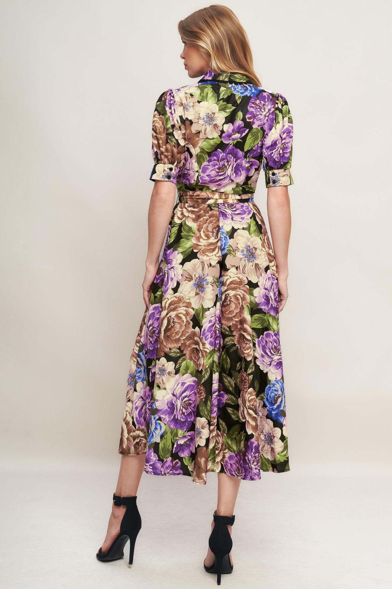 A printed woven midi dress featuring collar, short puff sleeve with cuff, button down closure and self sash tie