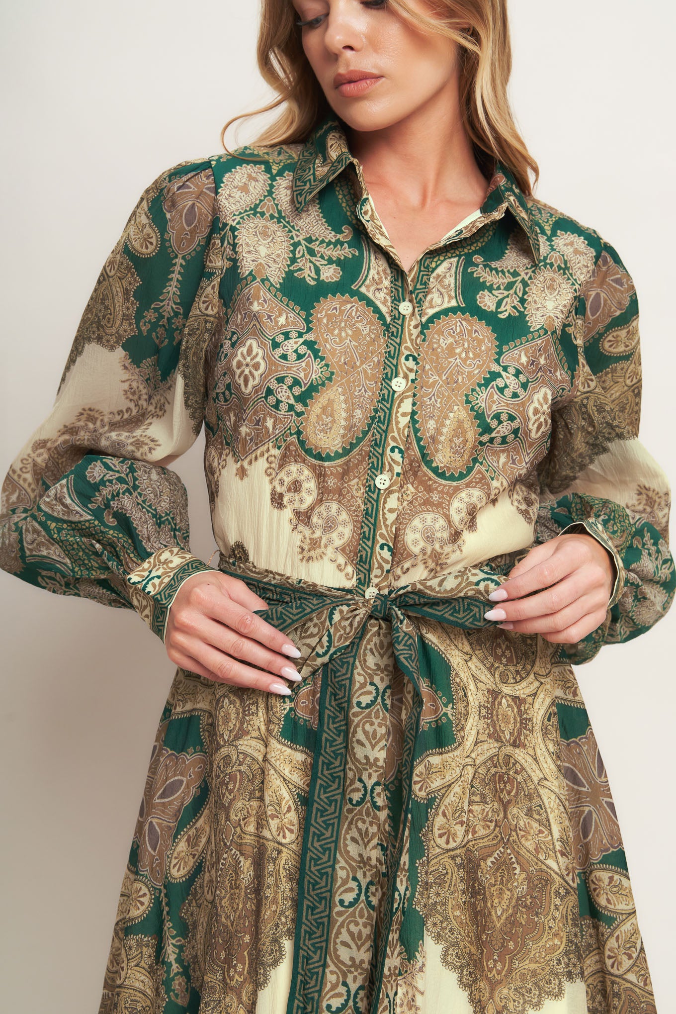 A printed woven midi dress featuring collar, front button down closure, long sleeve with cuff and circle skirt