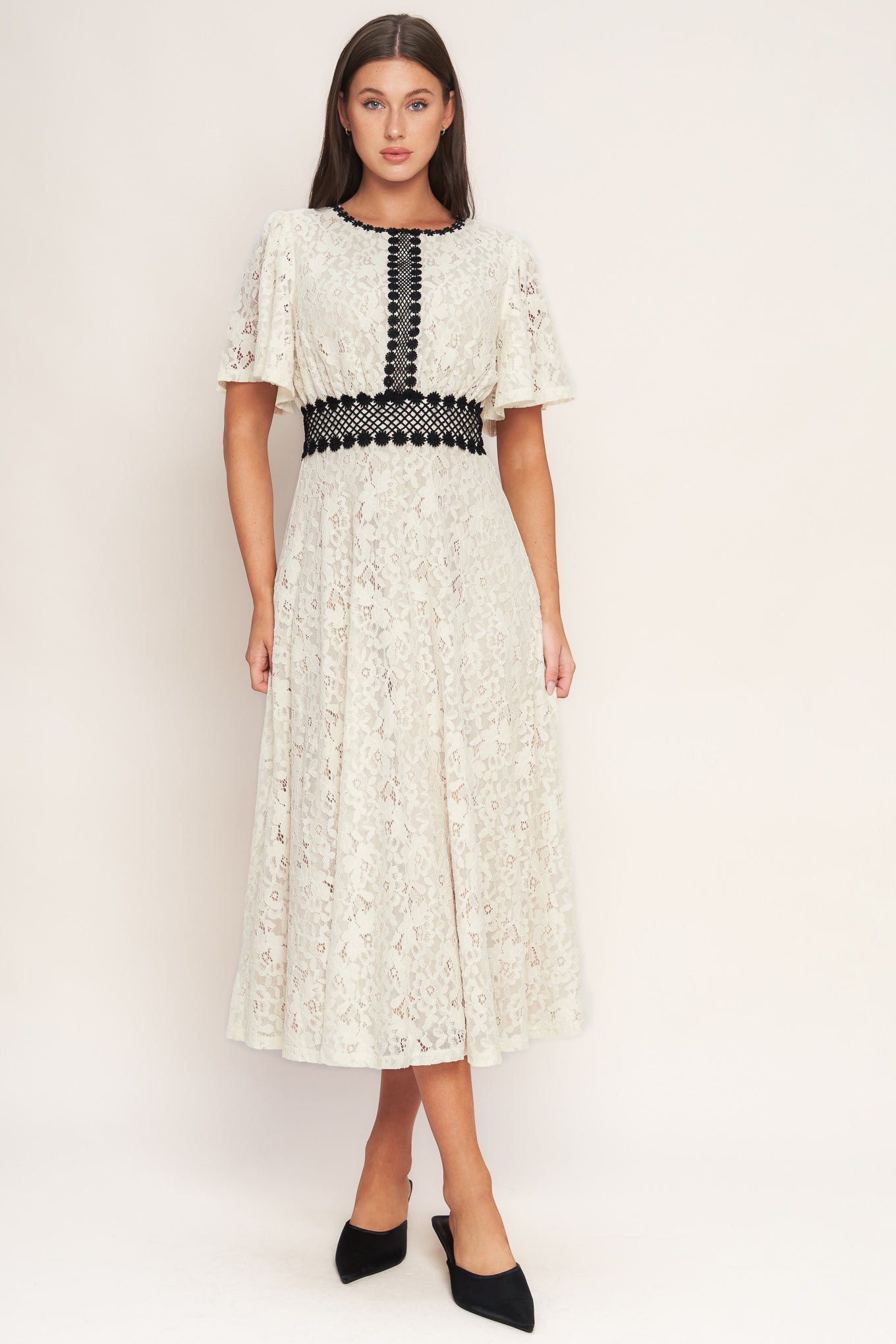 A solid woven lace midi dress featuring round neckline, lace inset detail, circle skirt and back zipper closure