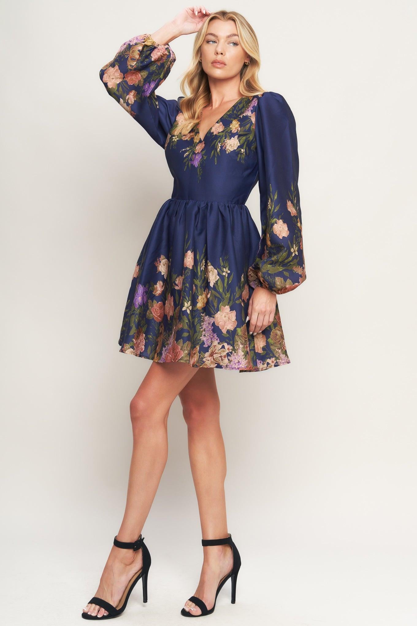 A printed woven mini dress featuring V neckline, long sleeve, full skirt and back zipper closure