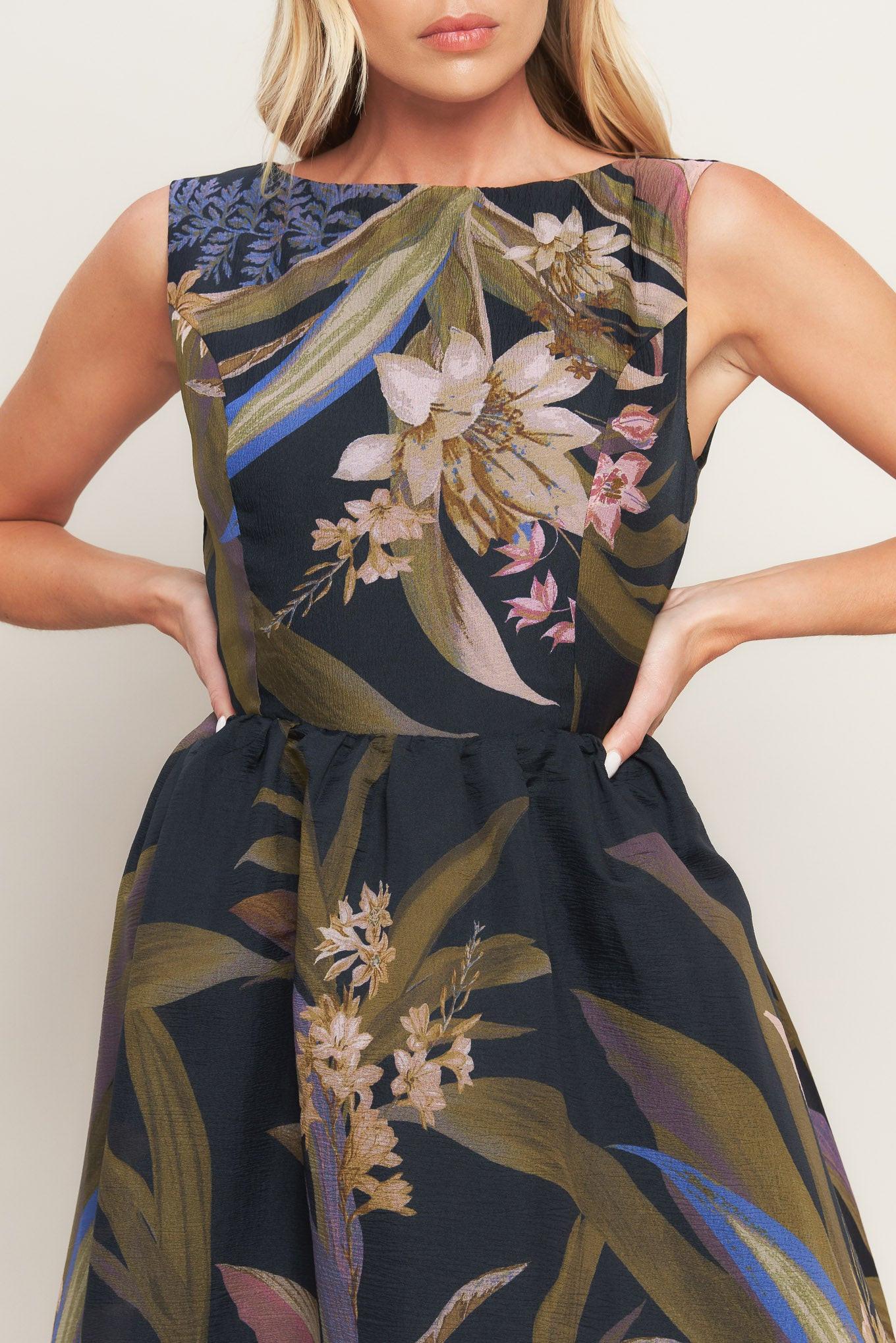 A printed woven midi dress featuring wide neckline, sleeveless, full skirt and back zipper closure