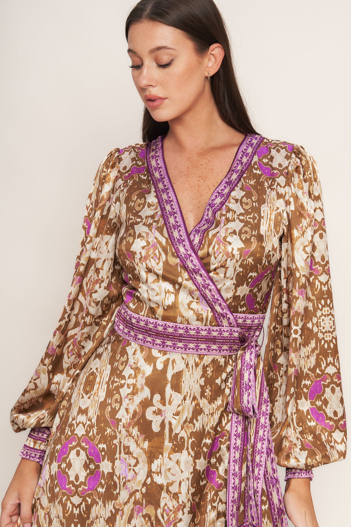 A printed woven midi true wrap dress featuring surplice neckline and long sleeve with smocked cuff