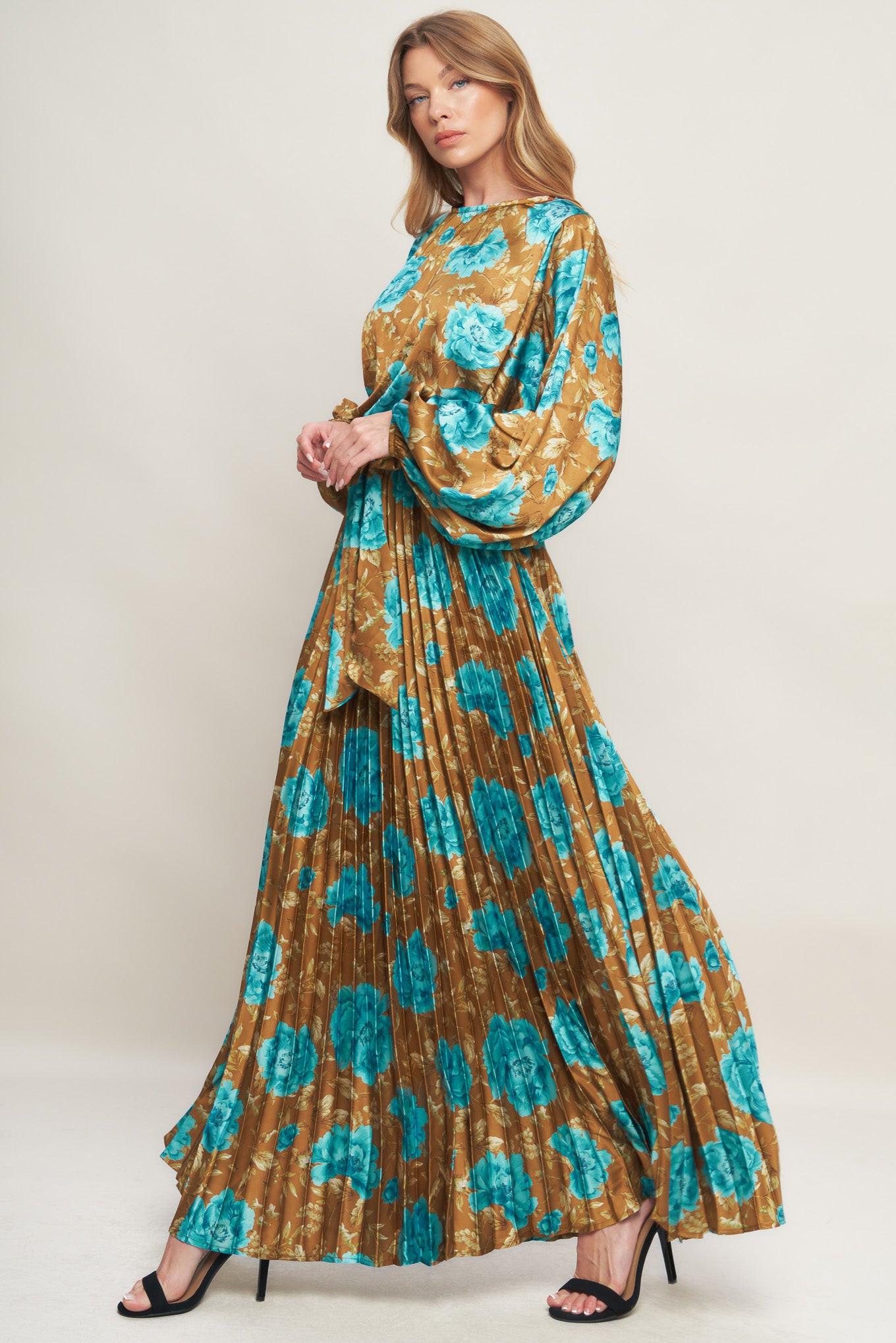 A printed woven satin maxi dress featuring round neckline, long sleeve, elasticized waist with pleated skirt and back button closure