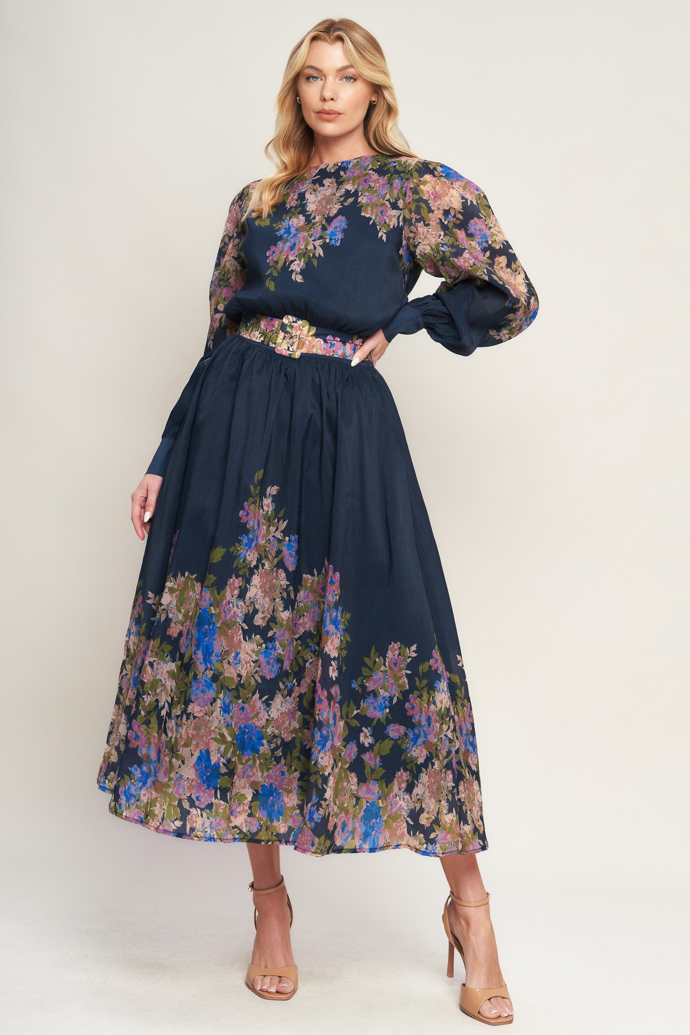 A printed woven midi dress featuring round neckline, long sleeve with wide cuff, waist band, full skirt and back zipper closure