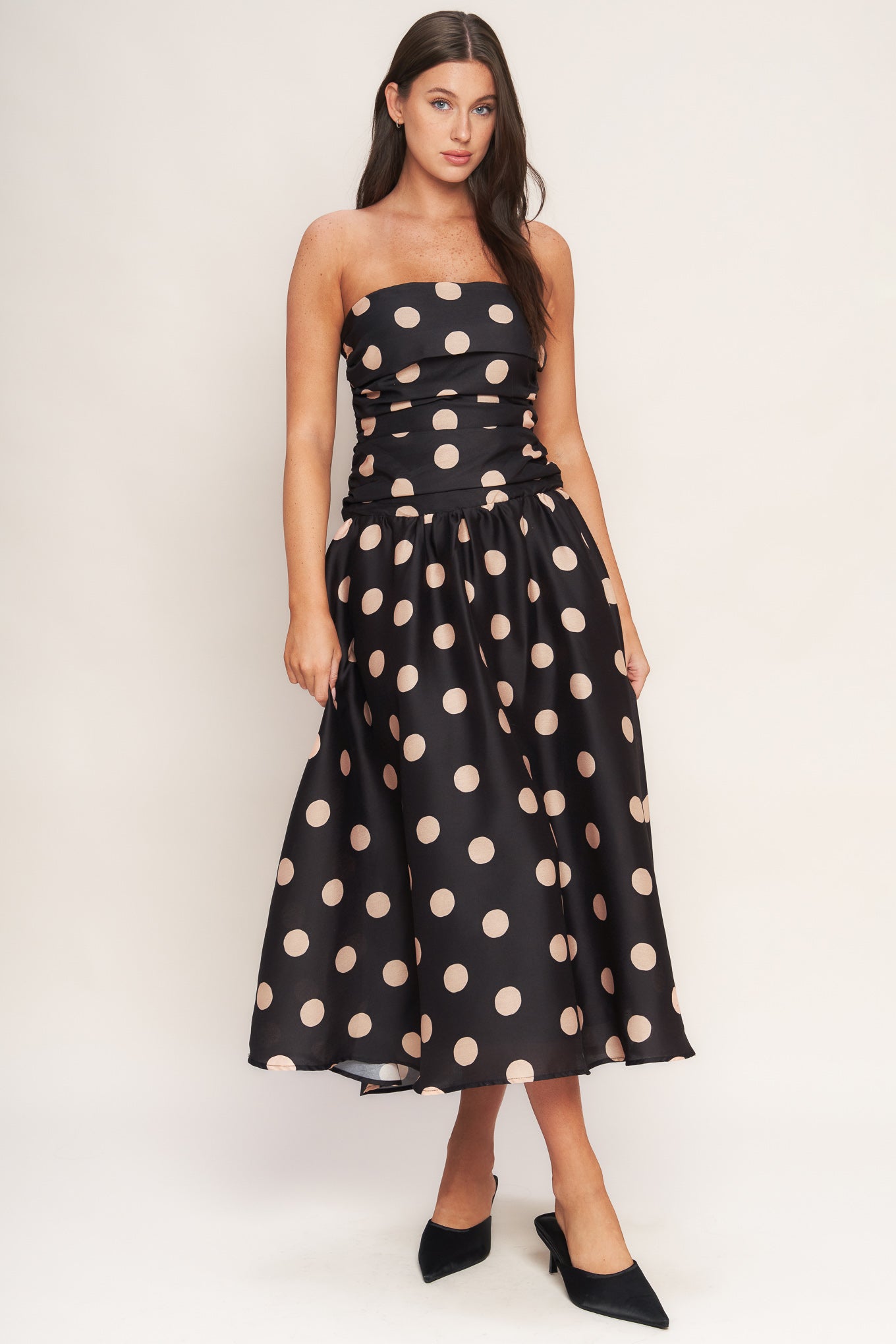 A printed woven midi dress featuring strapless, side shirred bodice, drop waistline, full skirt and smocked back bodice