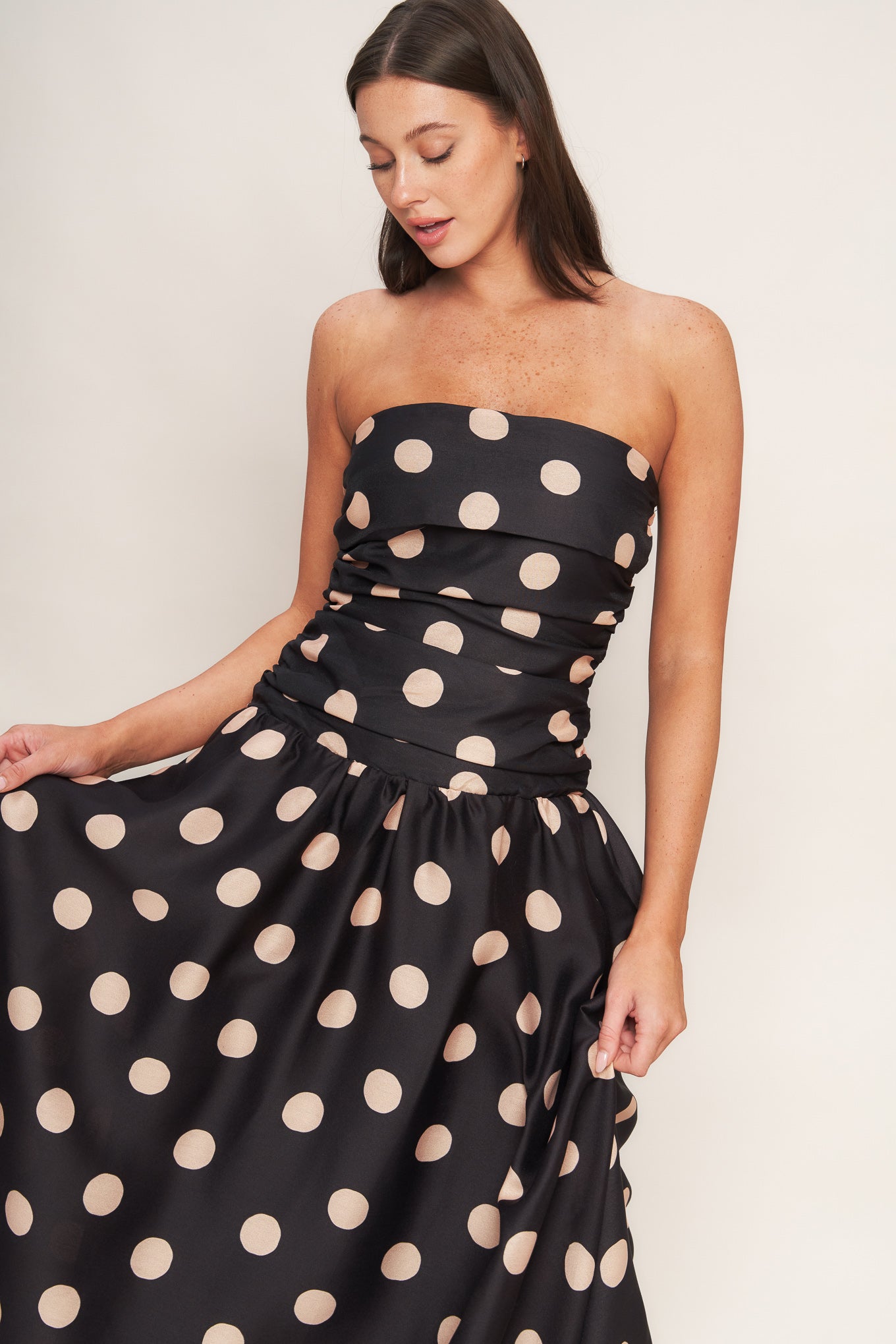 A printed woven midi dress featuring strapless, side shirred bodice, drop waistline, full skirt and smocked back bodice