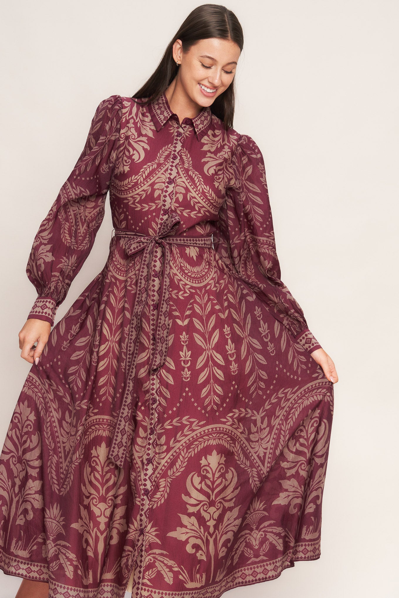 A printed woven midi dress featuring collar, front button down closure, long sleeve with circle skirt