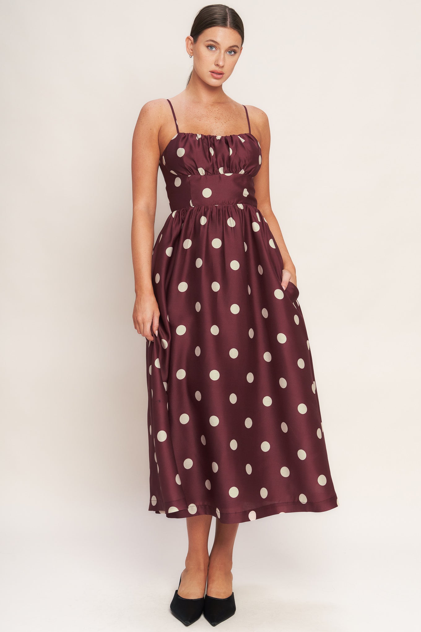 A printed woven midi dress featuring straight neckline, straps, shirred bodice, wide waist band, full skirt and back zipper closure