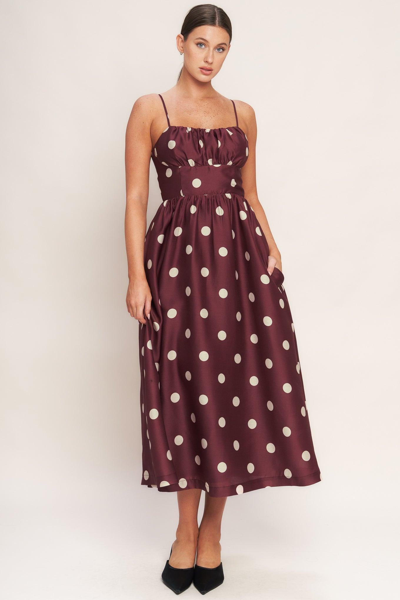A printed woven midi dress featuring straight neckline, straps, shirred bodice, wide waist band, full skirt and back zipper closure
