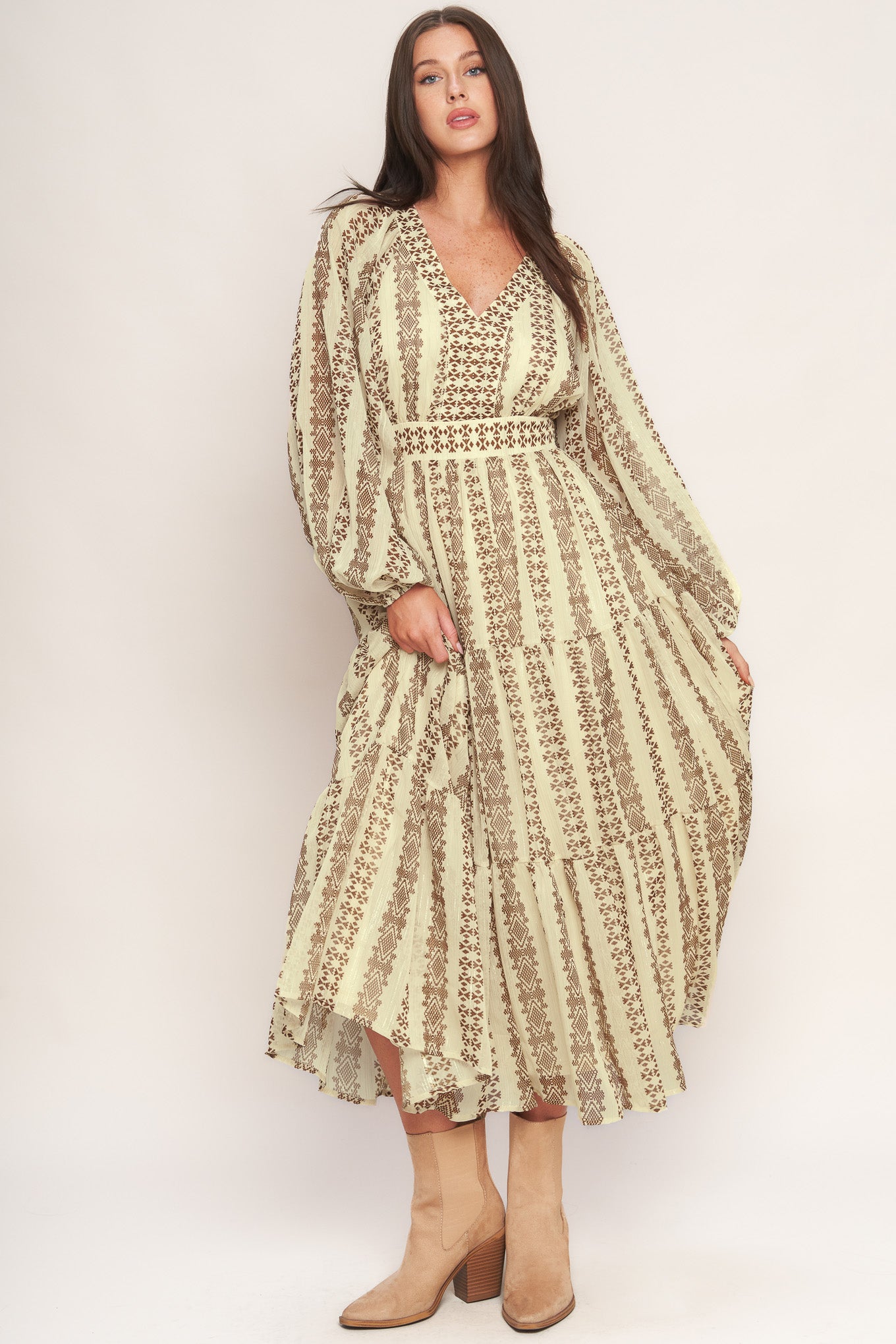 A printed metallic threaded woven midi dress featuring V neckline, long sleeve, tiered skirt and smocked back waist band