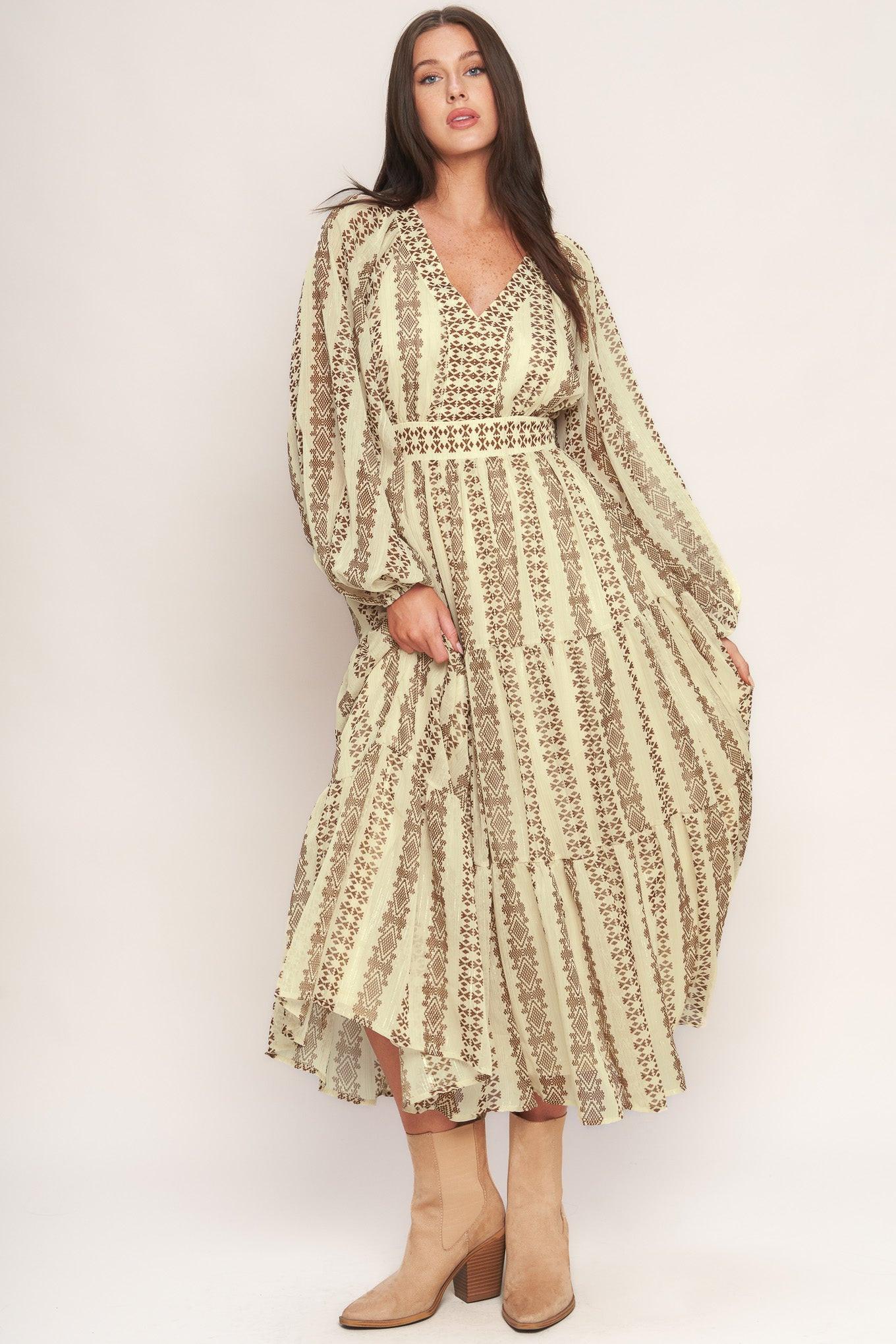 A printed metallic threaded woven midi dress featuring V neckline, long sleeve, tiered skirt and smocked back waist band