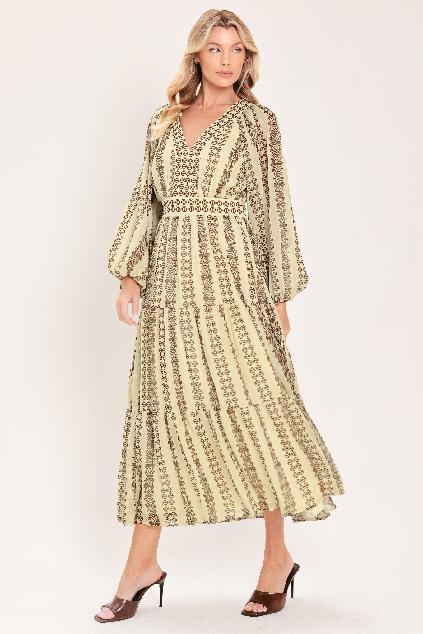 A woman modeling a long-sleeve midi dress with a beige and brown geometric pattern | Flying Tomato