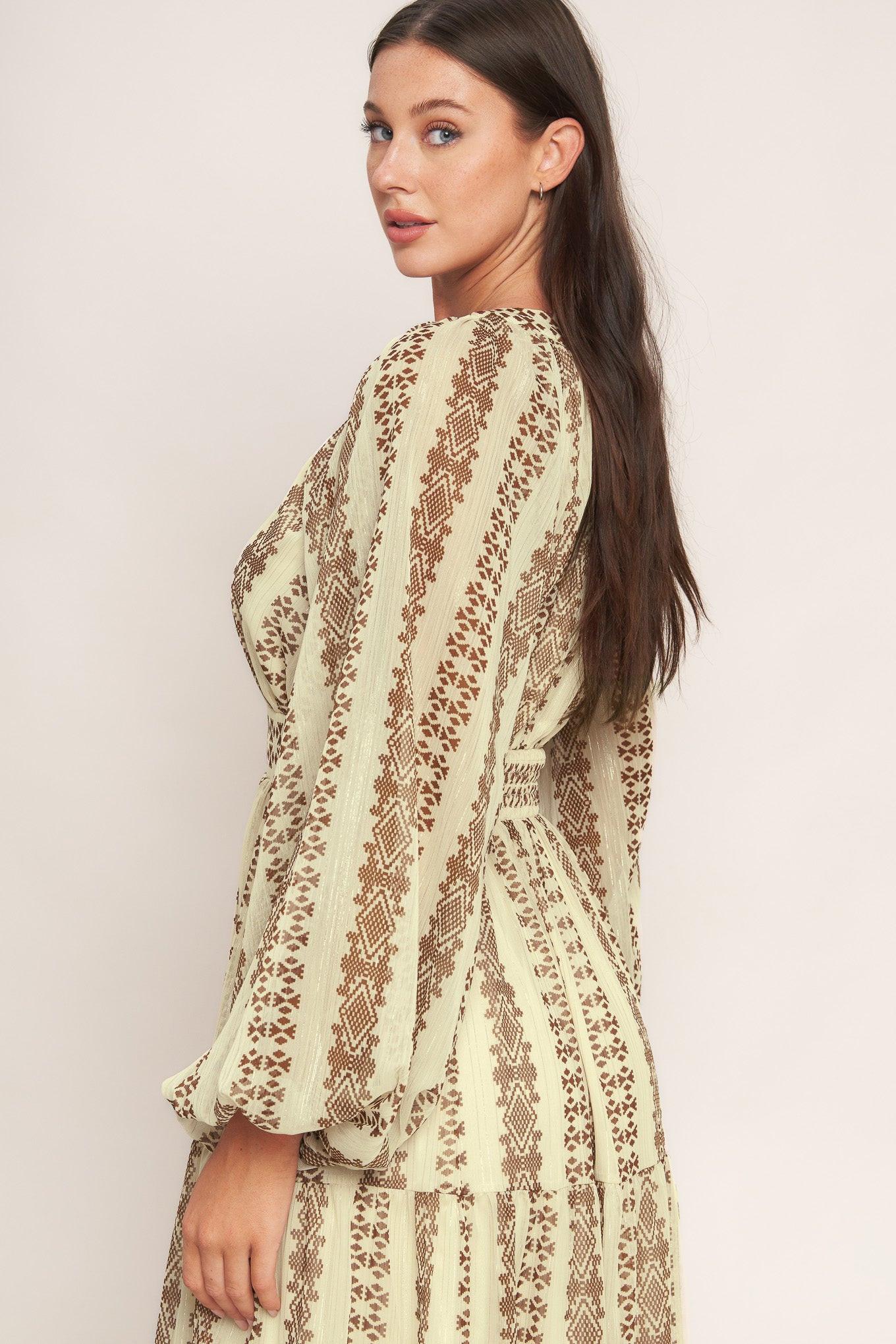 A printed metallic threaded woven midi dress featuring V neckline, long sleeve, tiered skirt and smocked back waist band