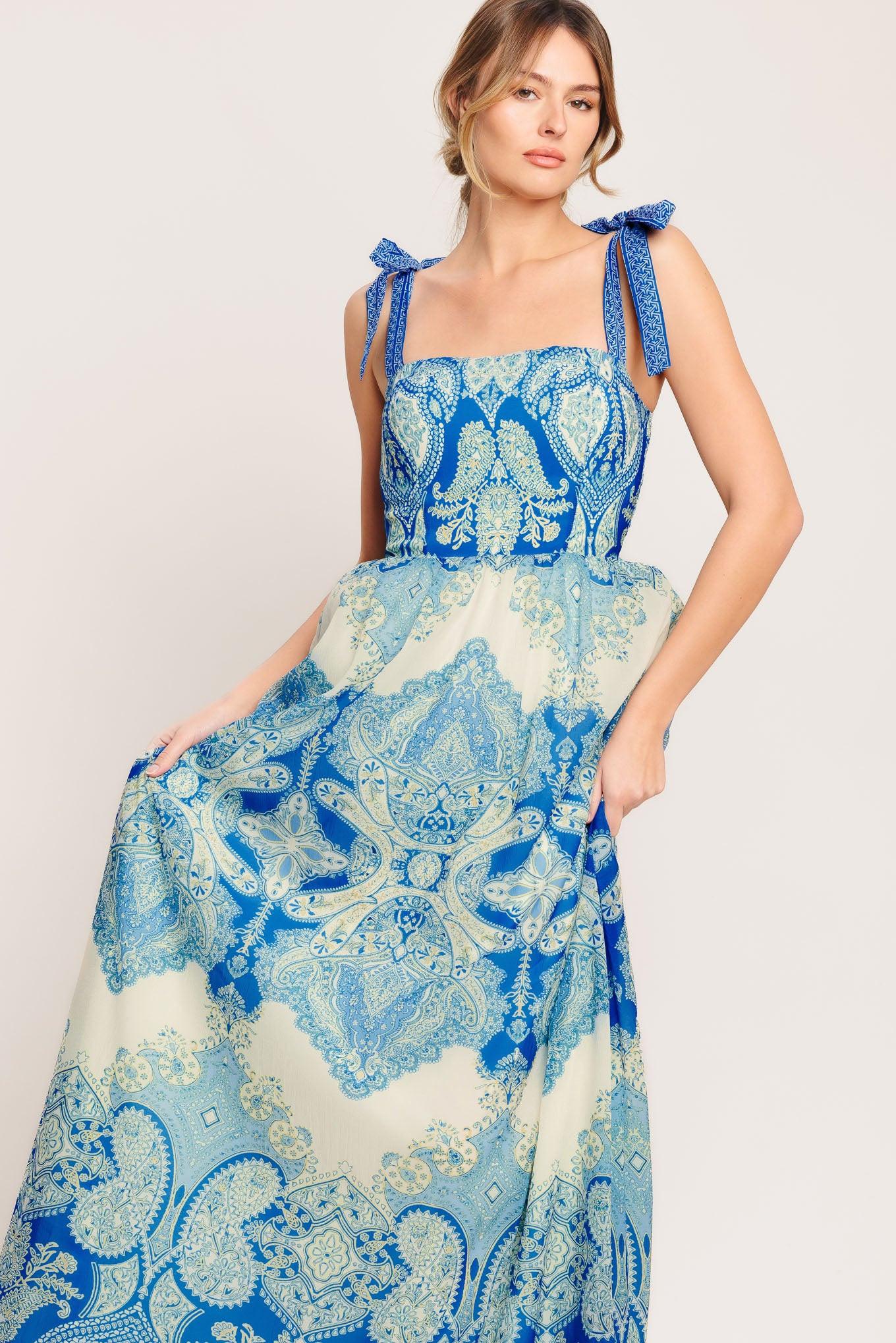 A printed woven maxi dress featuring straight neckline, shoulder ties, full skirt and smocked back bodice
Details:
Self: 100% Polyester
Lining: 100% Polyester
Size & Fit
-Model is 5`8" And Wearing Size Small
-Measurements Taken From Size Small
-Approx. Length: 60"