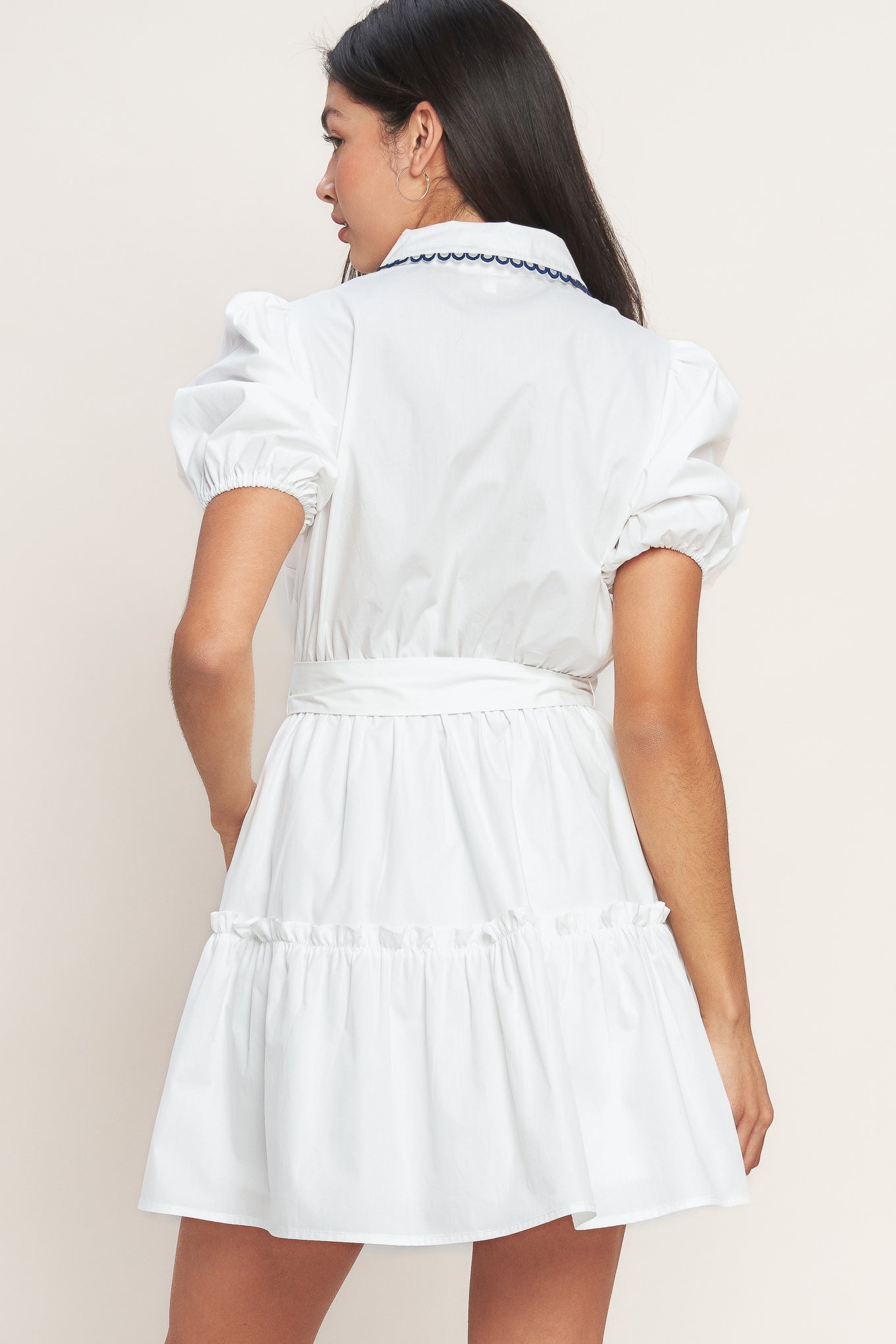 White short-sleeve button-front dress with navy trim and waist tie