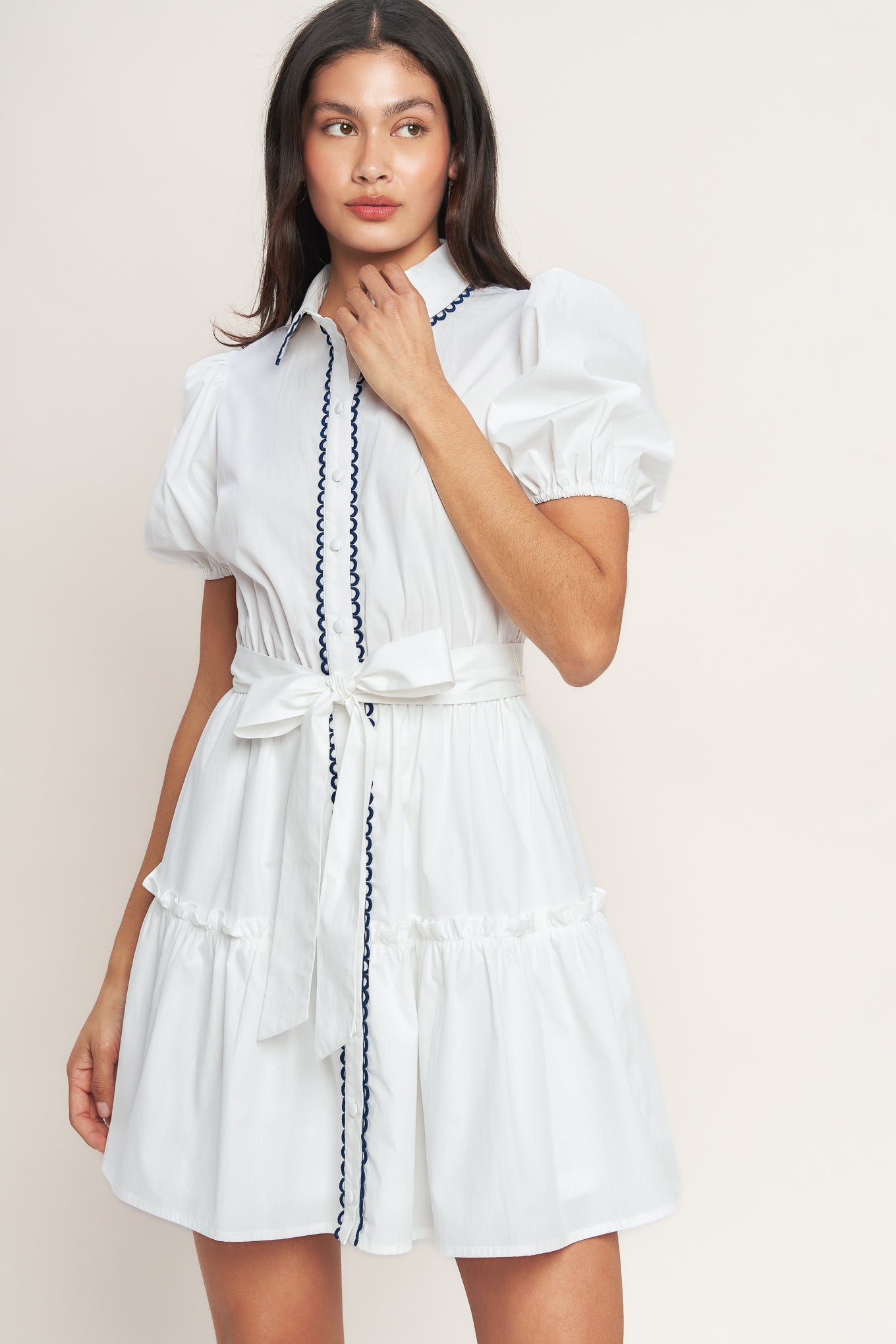 White short-sleeve button-front dress with navy trim and waist tie