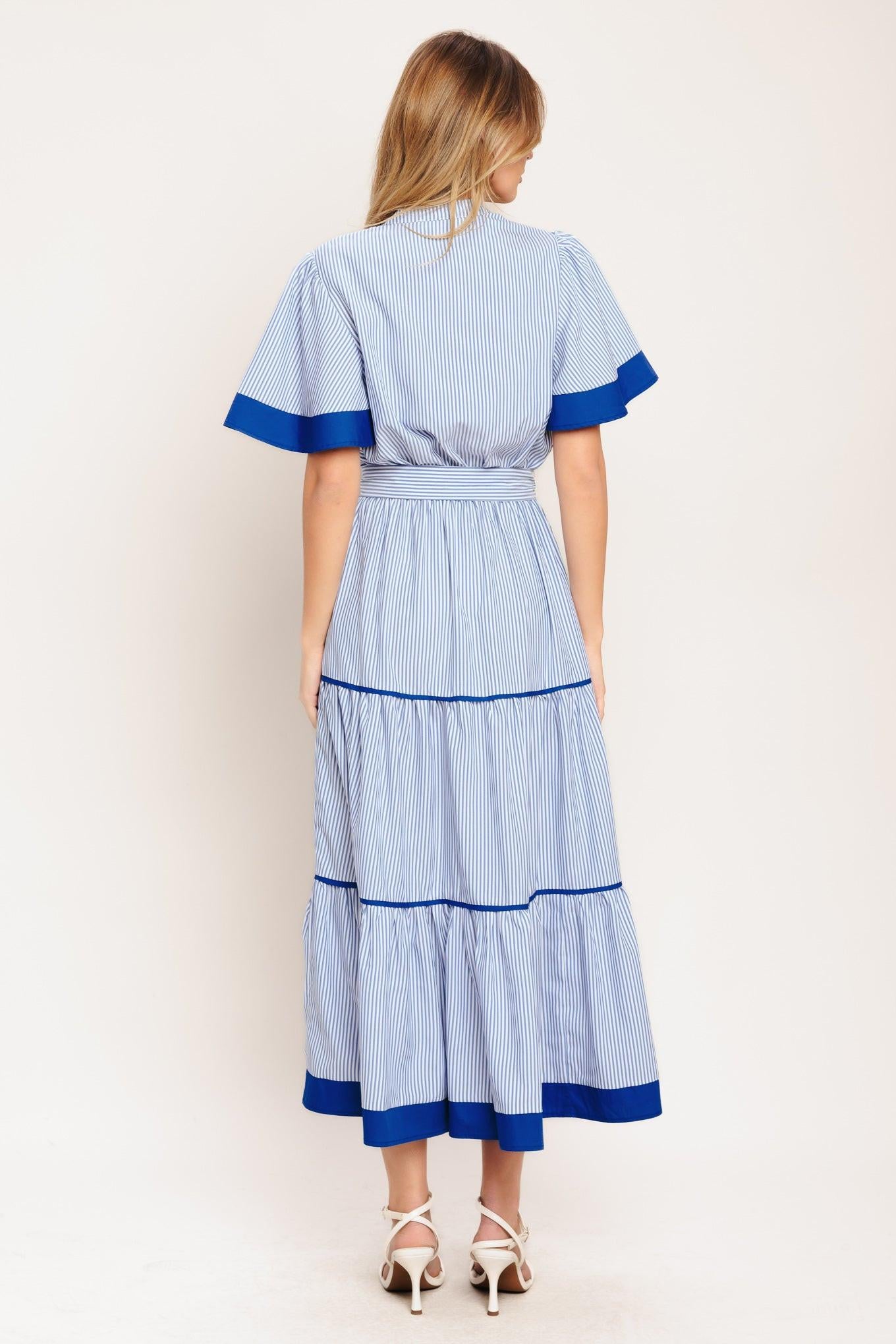 A striped woven midi dress featuring high neckline with V front, short flutter sleeve, button down bodice, elasticized waist with self sash tie and tiered skirt
Details:
Self: 100% Polyester
Contrast: 100% Cotton
Lining: 100% Polyester
Size & Fit
-Model is 5`8" And Wearing Size Small
-Measurements Taken From Size Small
-Approx. Length: 54"