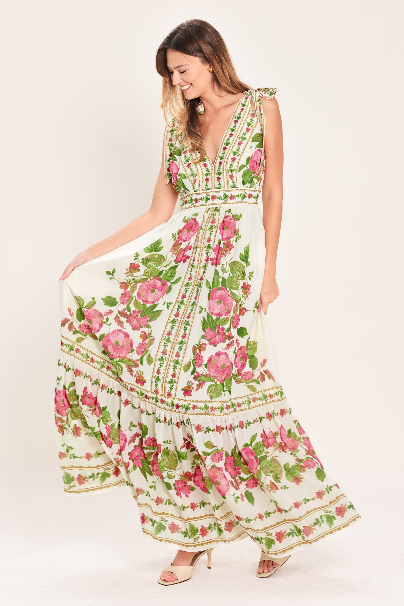 Woman wearing a floral maxi dress featuring V neckline, shoulder ties and smocked back waist band | Flying Tomato