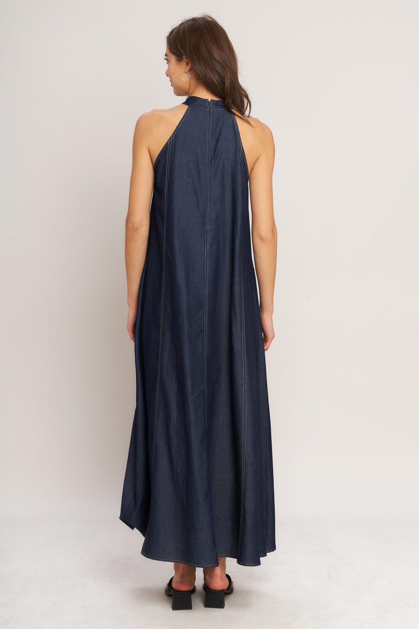 A solid woven midi halter dress with back neck button closure and side pockets