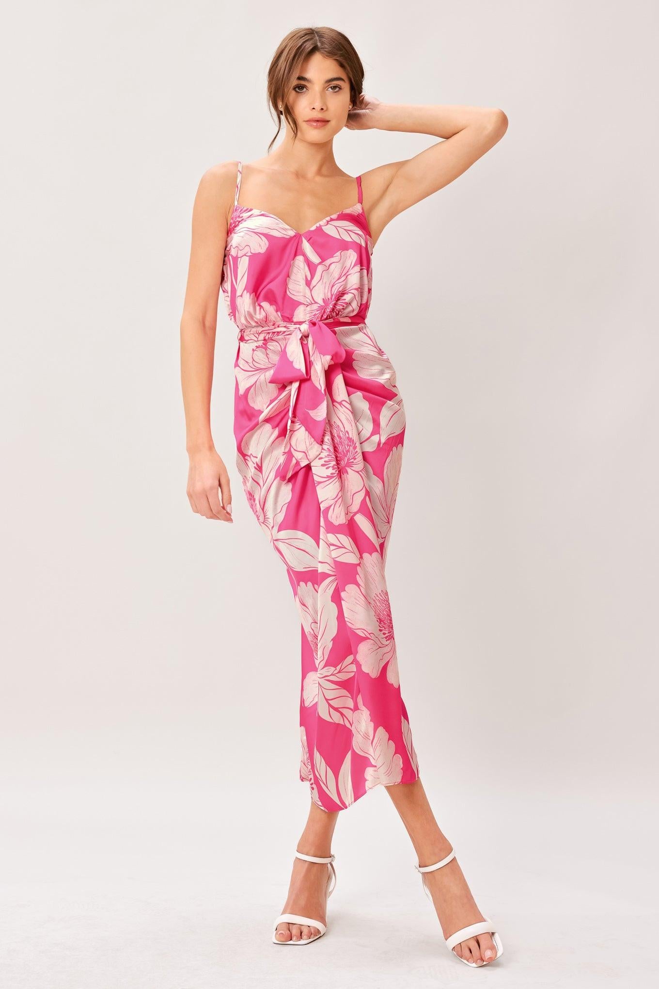 A printed woven midi dress featuring cami top, self sash, waterfall front and elastic back waist