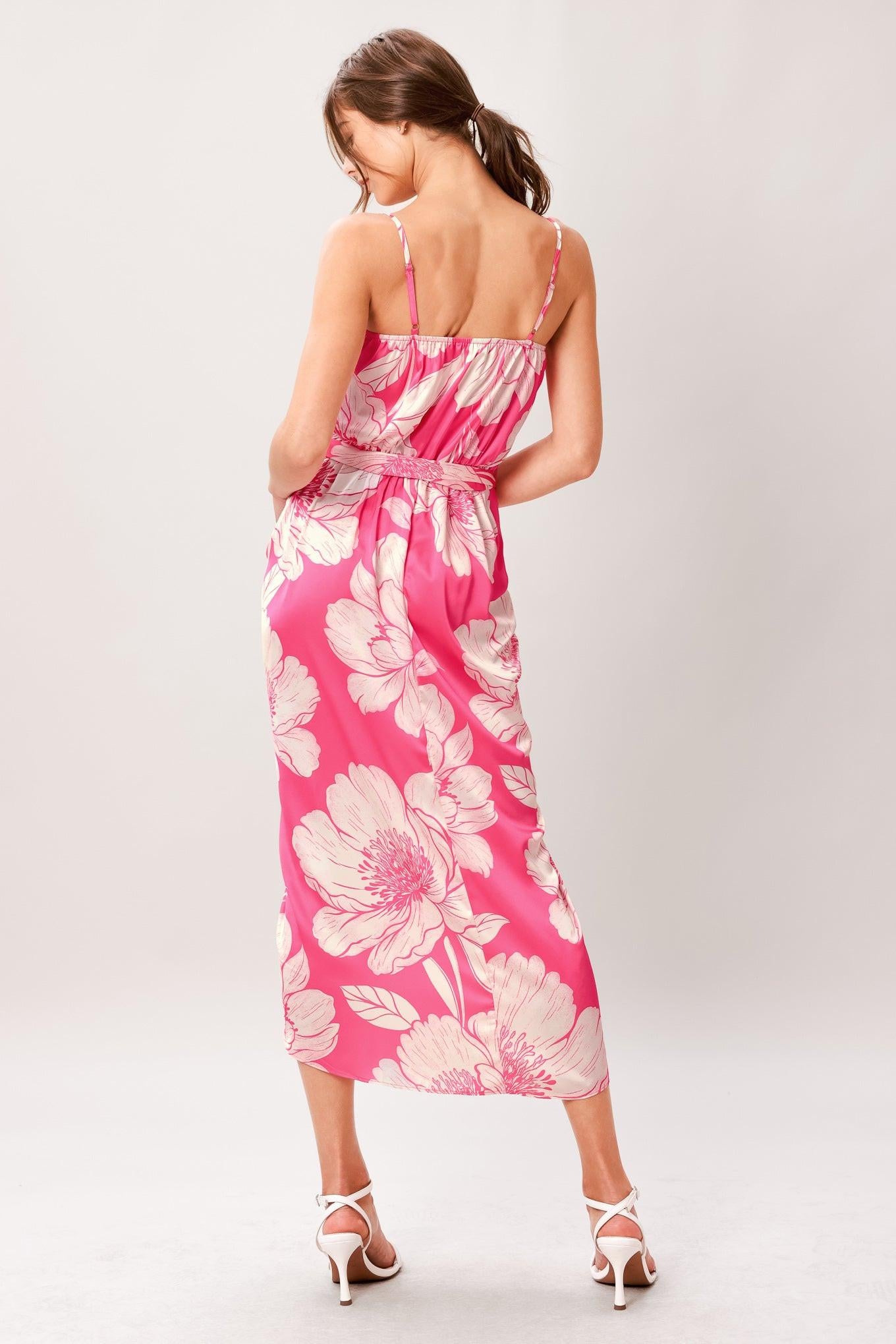 A printed woven midi dress featuring cami top, self sash, waterfall front and elastic back waist