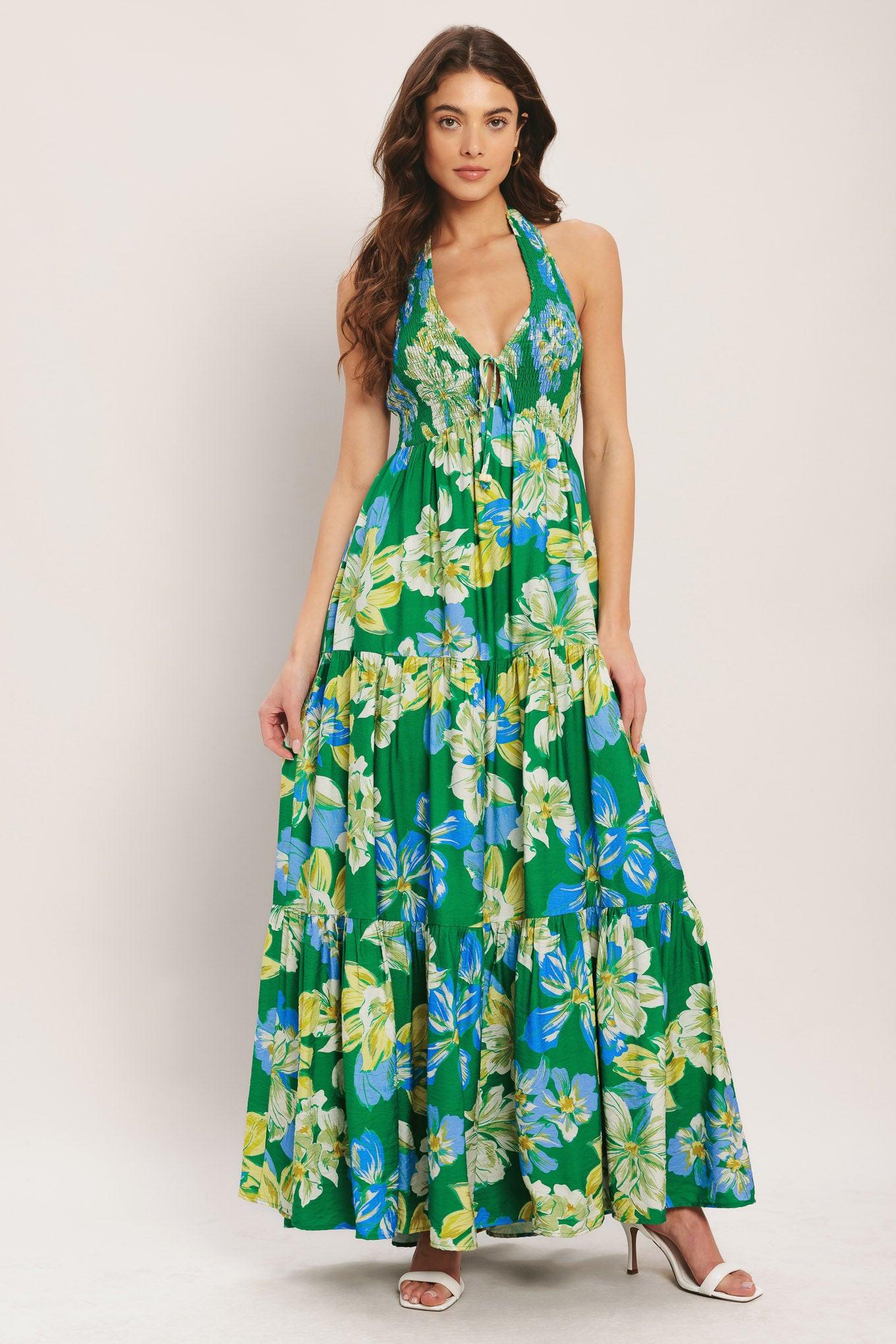Woman wearing a green floral dress on a white background