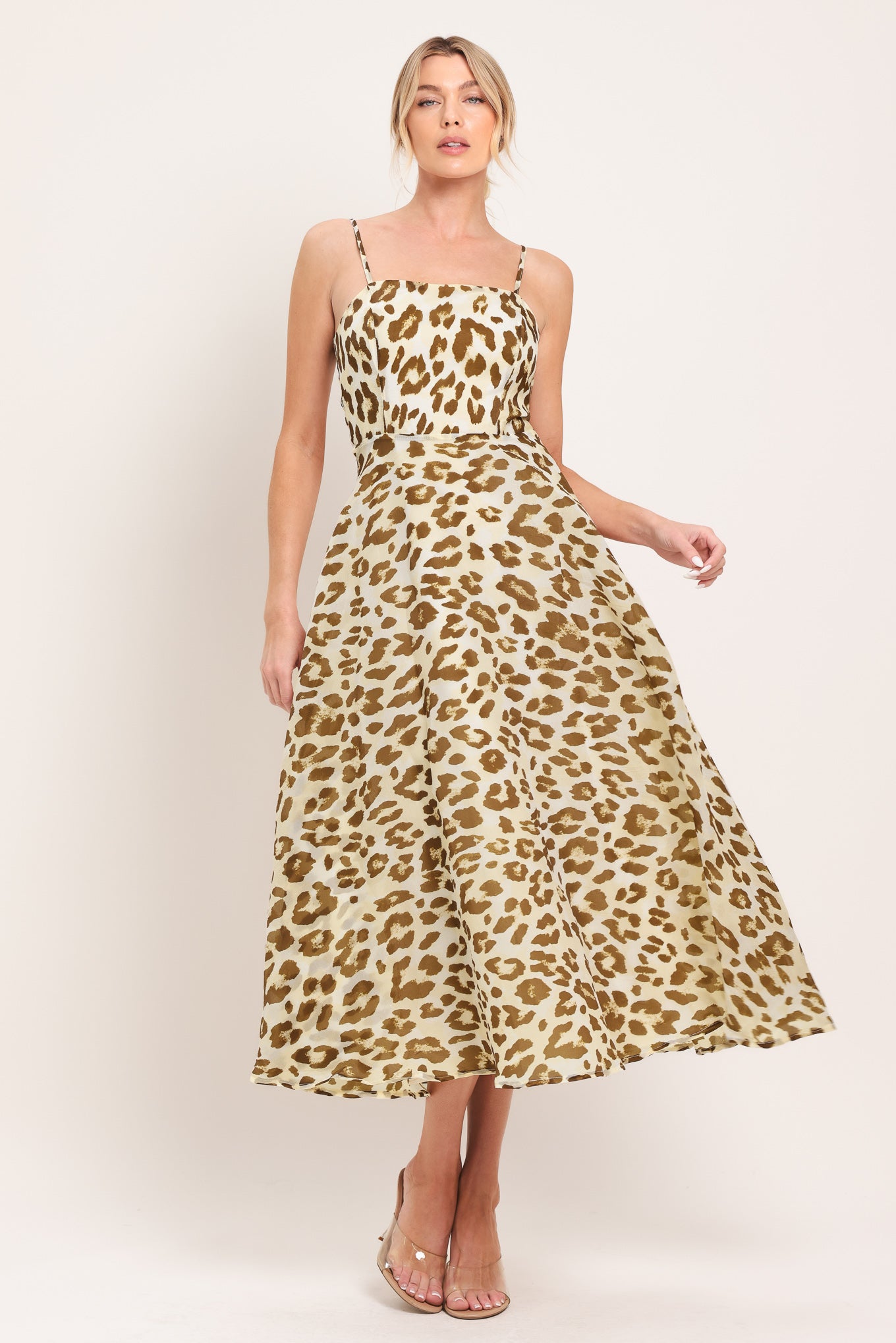 Woman wearing a leopard print midi dress featuring straight neckline, straps, full circle skirt and back zipper closure | Flying Tomato