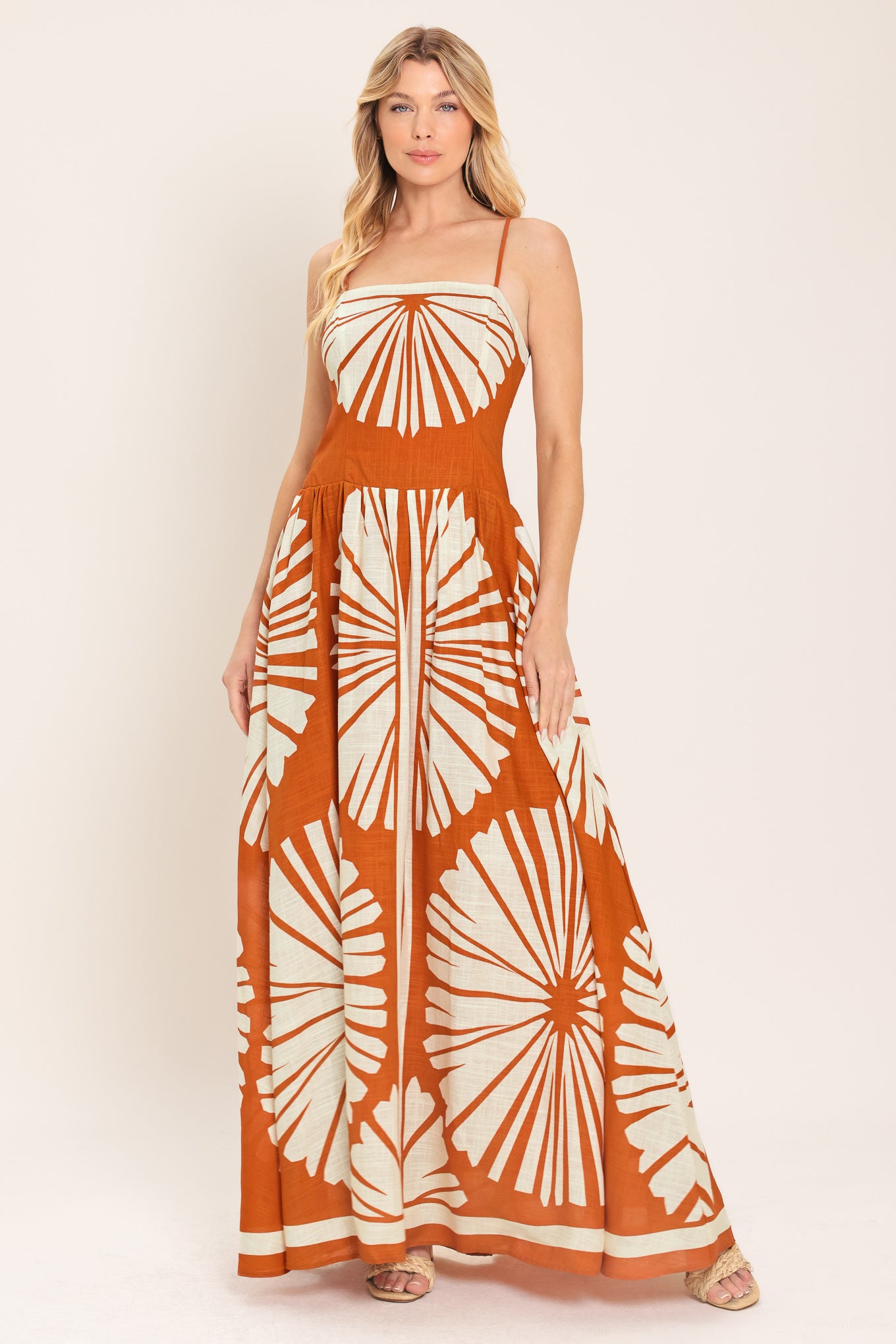 Woman wearing a maxi dress with an almond orange and white pattern | Flying Tomato