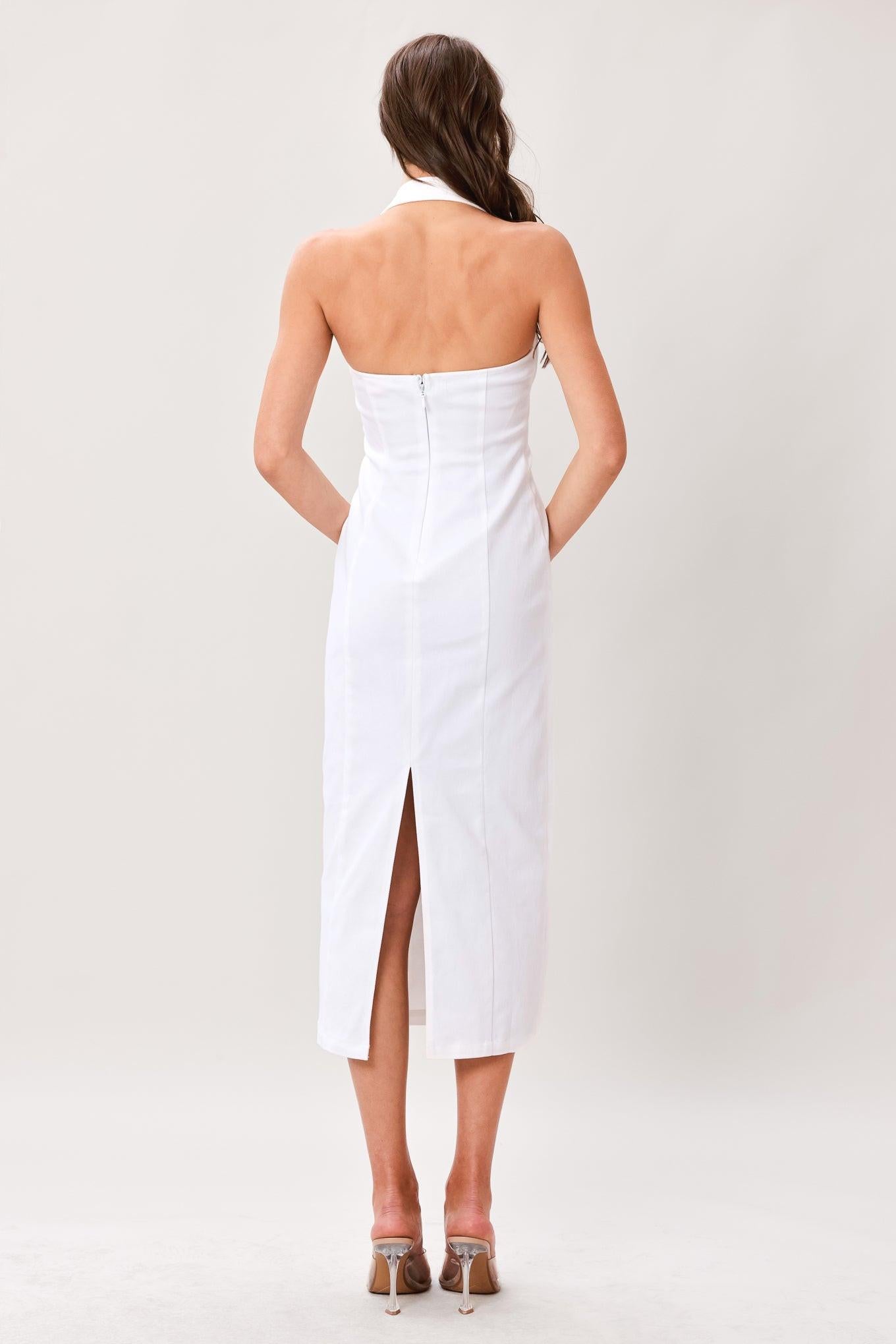 Woman wearing a white solid woven midi dress featuring straight neckline with halter strap and button, pencil skirt and back zipper closure