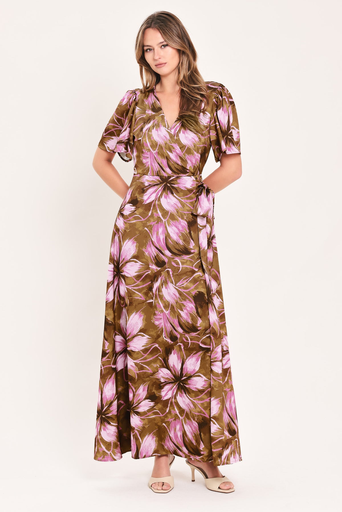 A woman modeling a brown and pink floral maxi dress with puff sleeves and a V-neckline | Flying Tomato
