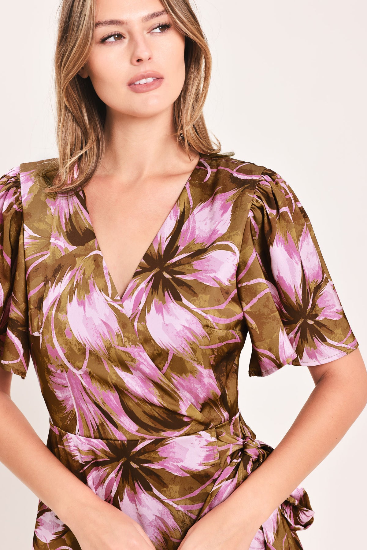A woman modeling a brown and pink floral maxi dress with puff sleeves and a V-neckline | Flying Tomato