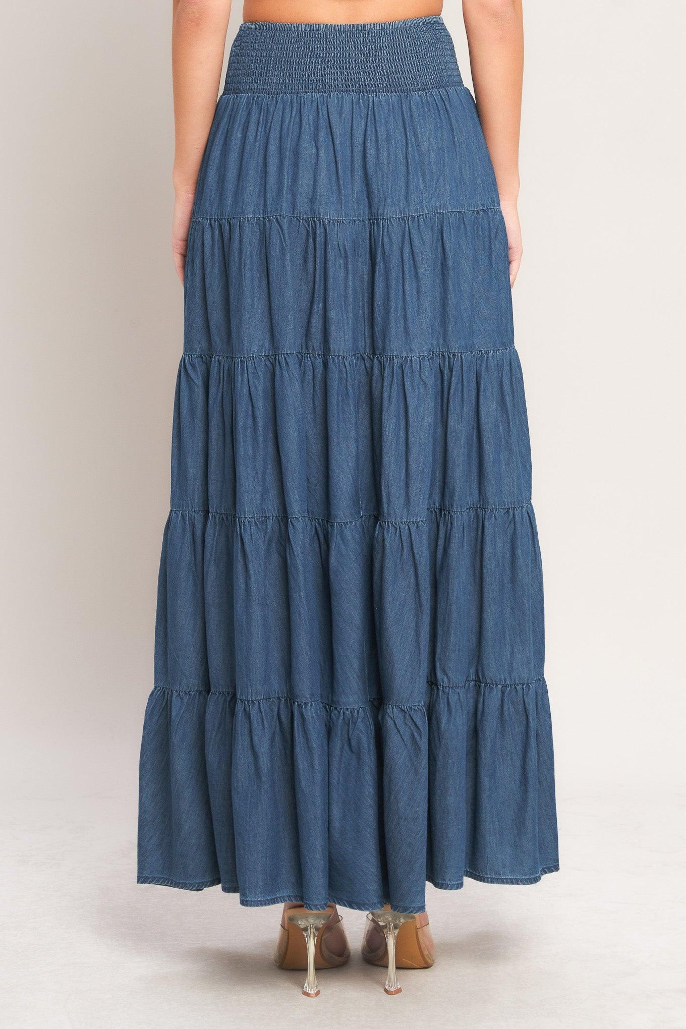 Blue tiered skirt worn by a person on a plain background