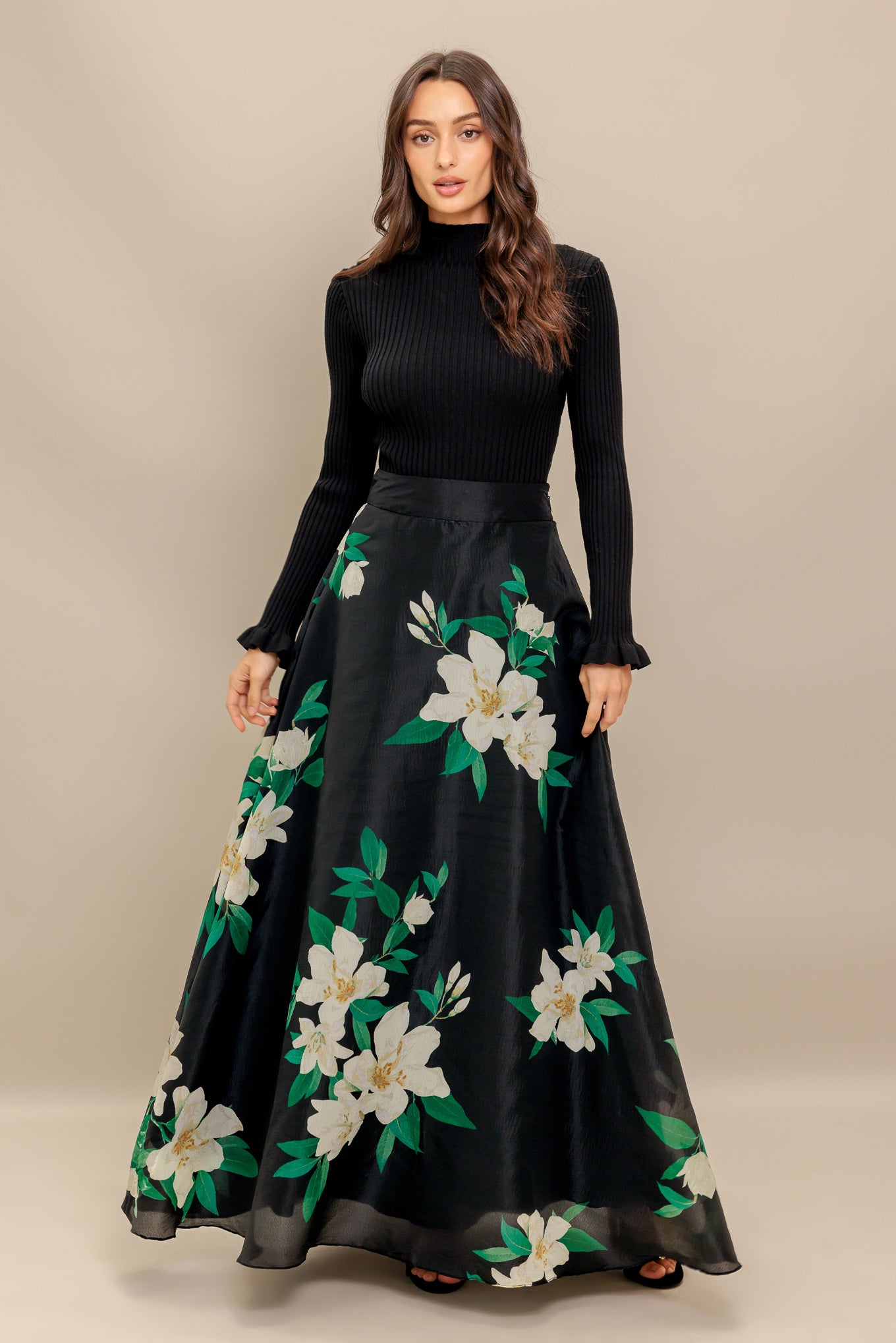 A black and white floral printed woven maxi skirt with side zipper closure
