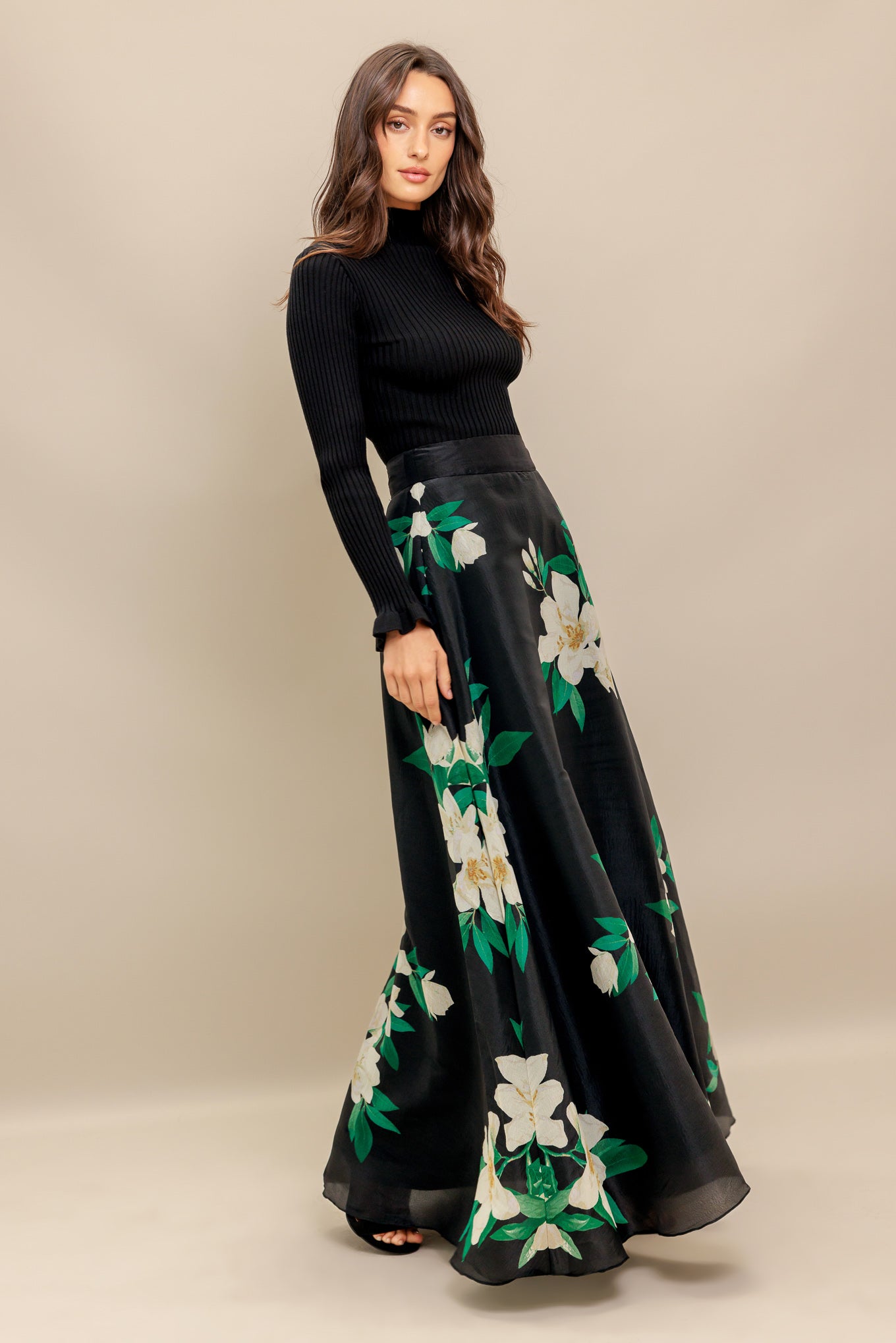 A black and white floral printed woven maxi skirt with side zipper closure