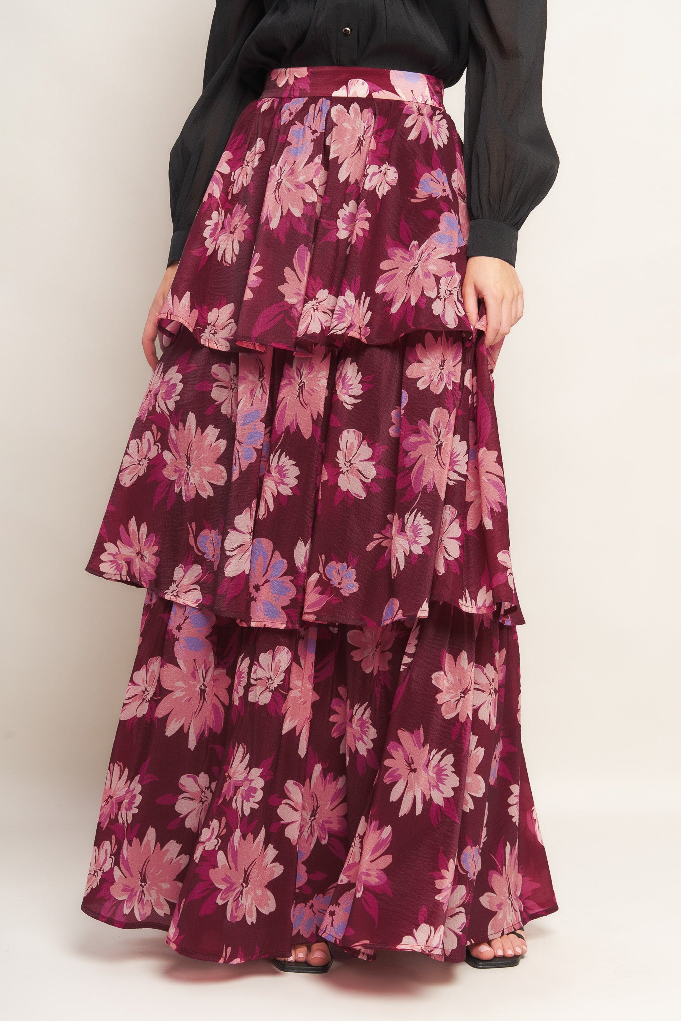 A printed woven maxi skirt with layers and side zipper closure.