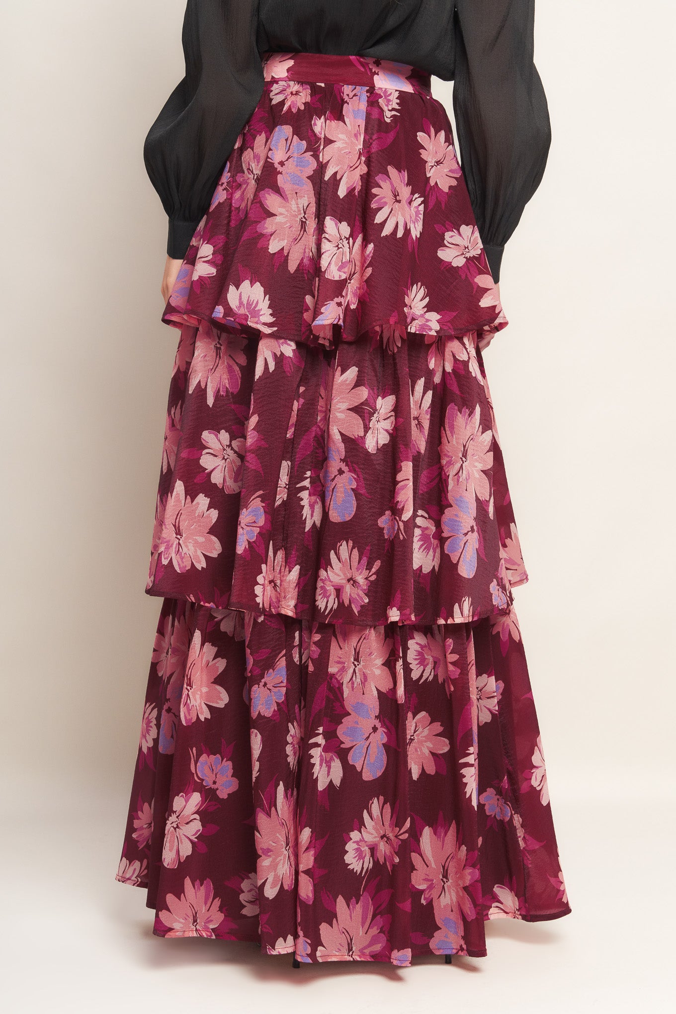 A printed woven maxi skirt with layers and side zipper closure.