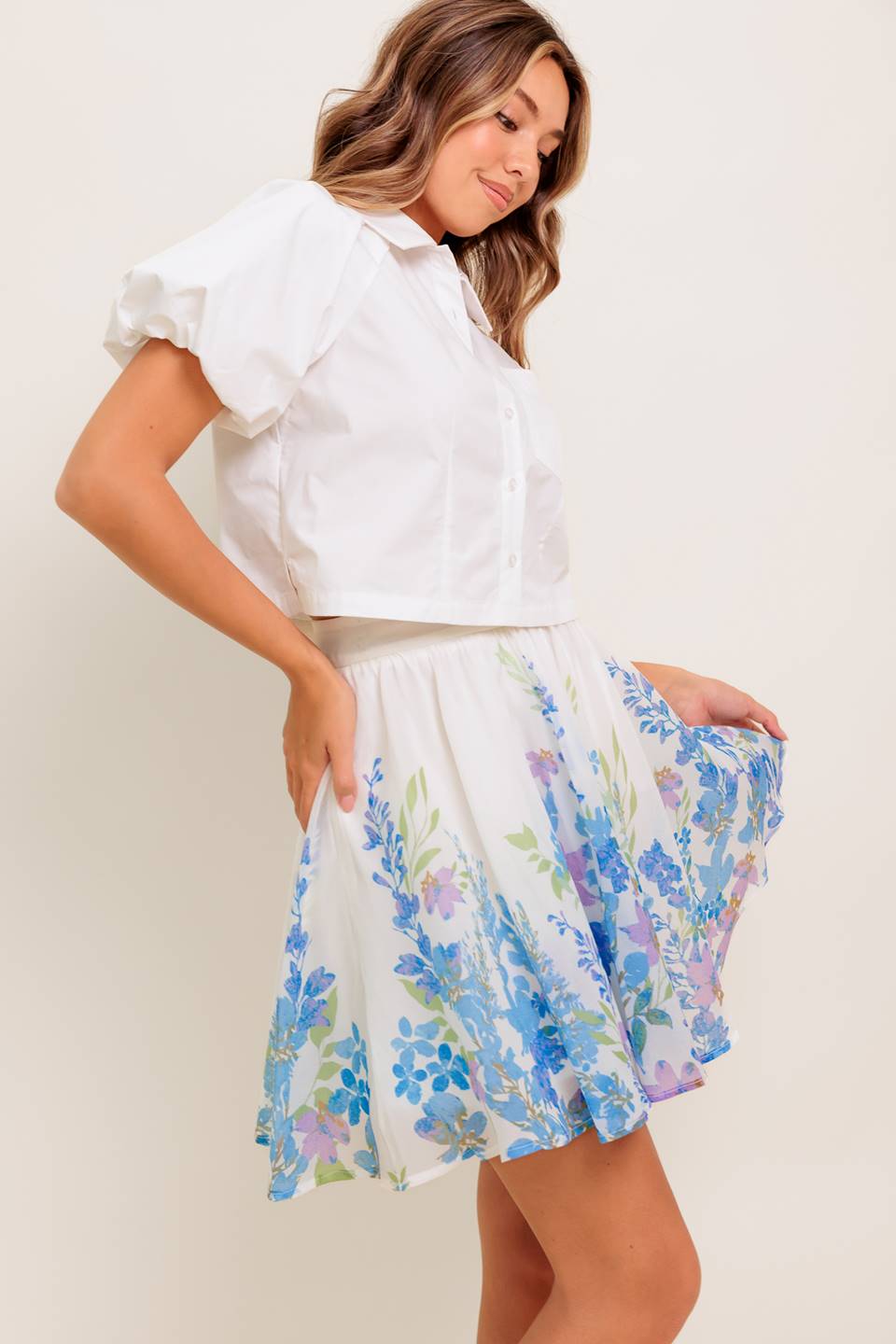 A printed woven mini full skirt with side zipper closure.
