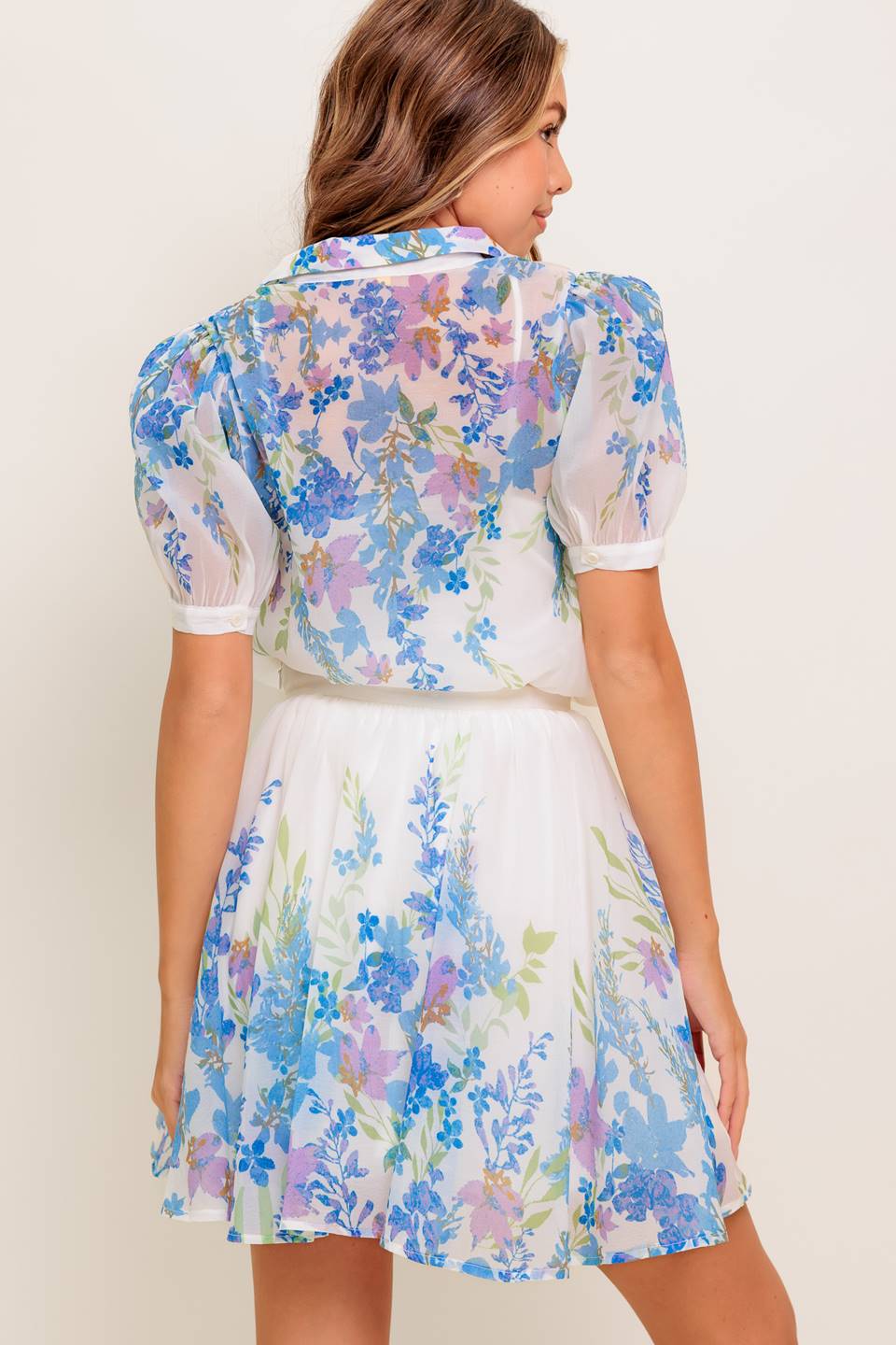 A printed woven mini full skirt with side zipper closure.