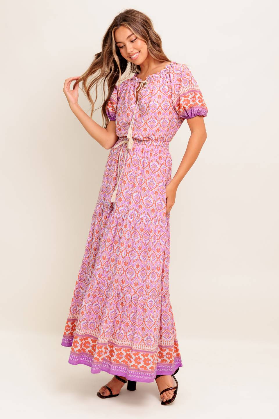 A printed woven maxi skirt featuring elasticized waist with contrasting tie and tiered bottom.